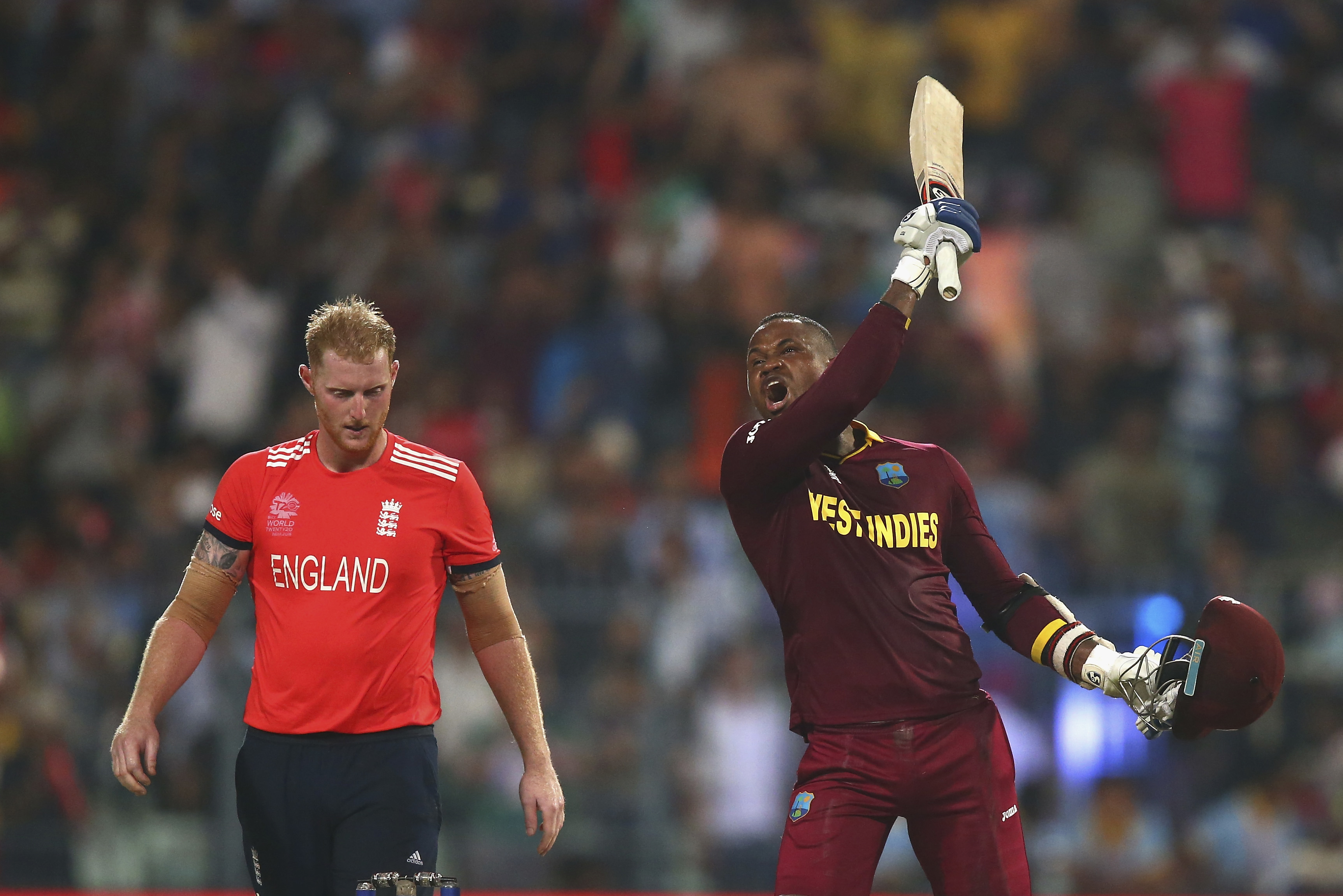 KOLKATA, WEST BENGAL - APRIL 03: Marlon Samuels of the West Indies celebrates after Carlos Brathwaite of the West Indies hit the second six of the last over as Ben Stokes of England looks on during the ICC World Twenty20 India 2016 Final match between England and West Indies at Eden Gardens on April 3, 2016 in Kolkata, India.  (Photo by Ryan Pierse/Getty Images)