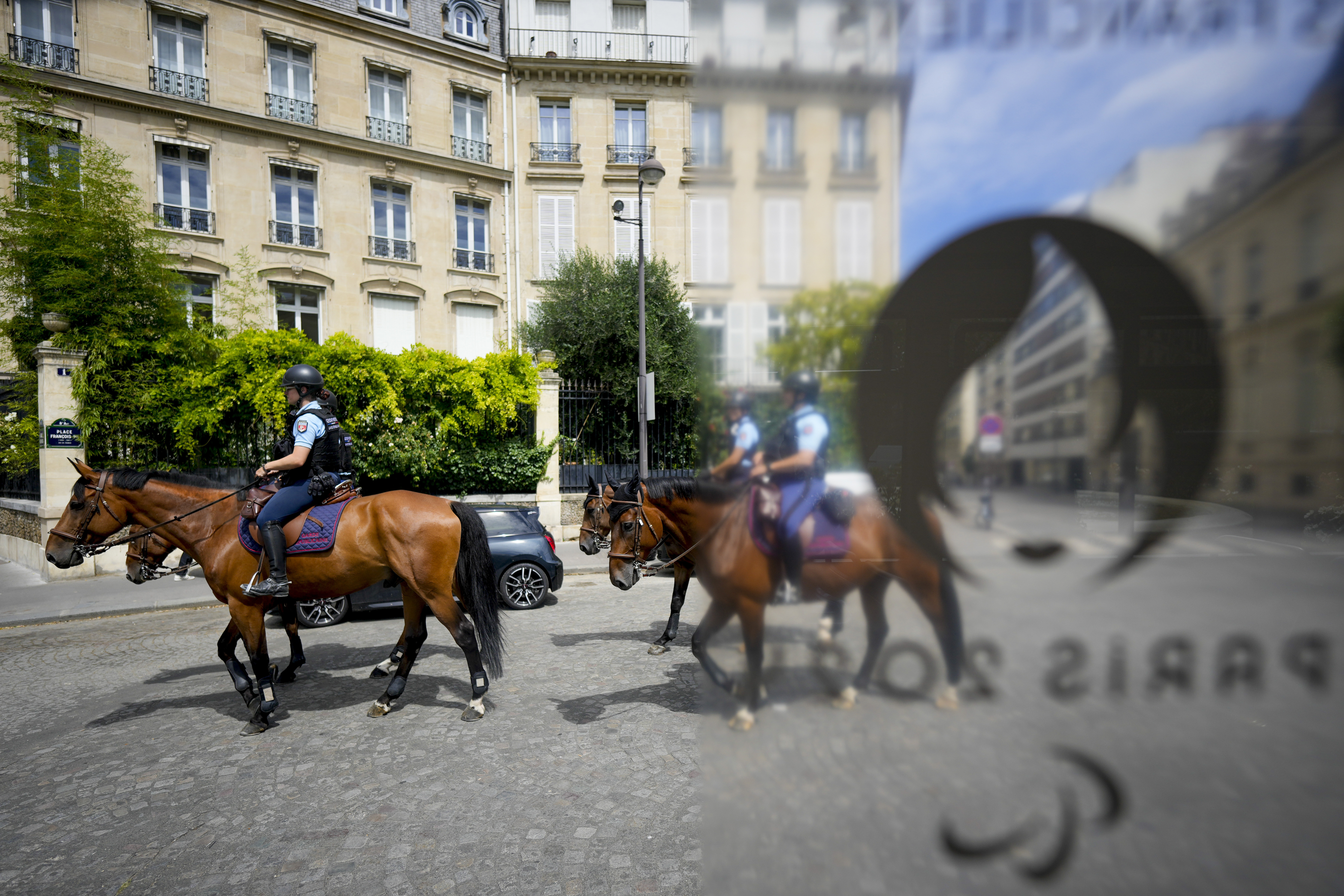 Police officers on horses patrol the streets at the 2024 Summer Olympics, Thursday, July 25, 2024, in Paris, France.