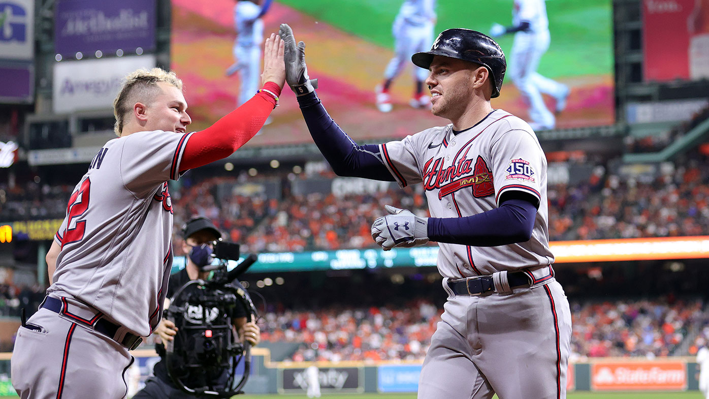 Freddie Freeman #5 of the Atlanta Braves celebrates with Joc Pederson #22 after hitting a solo home run against the Houston Astros