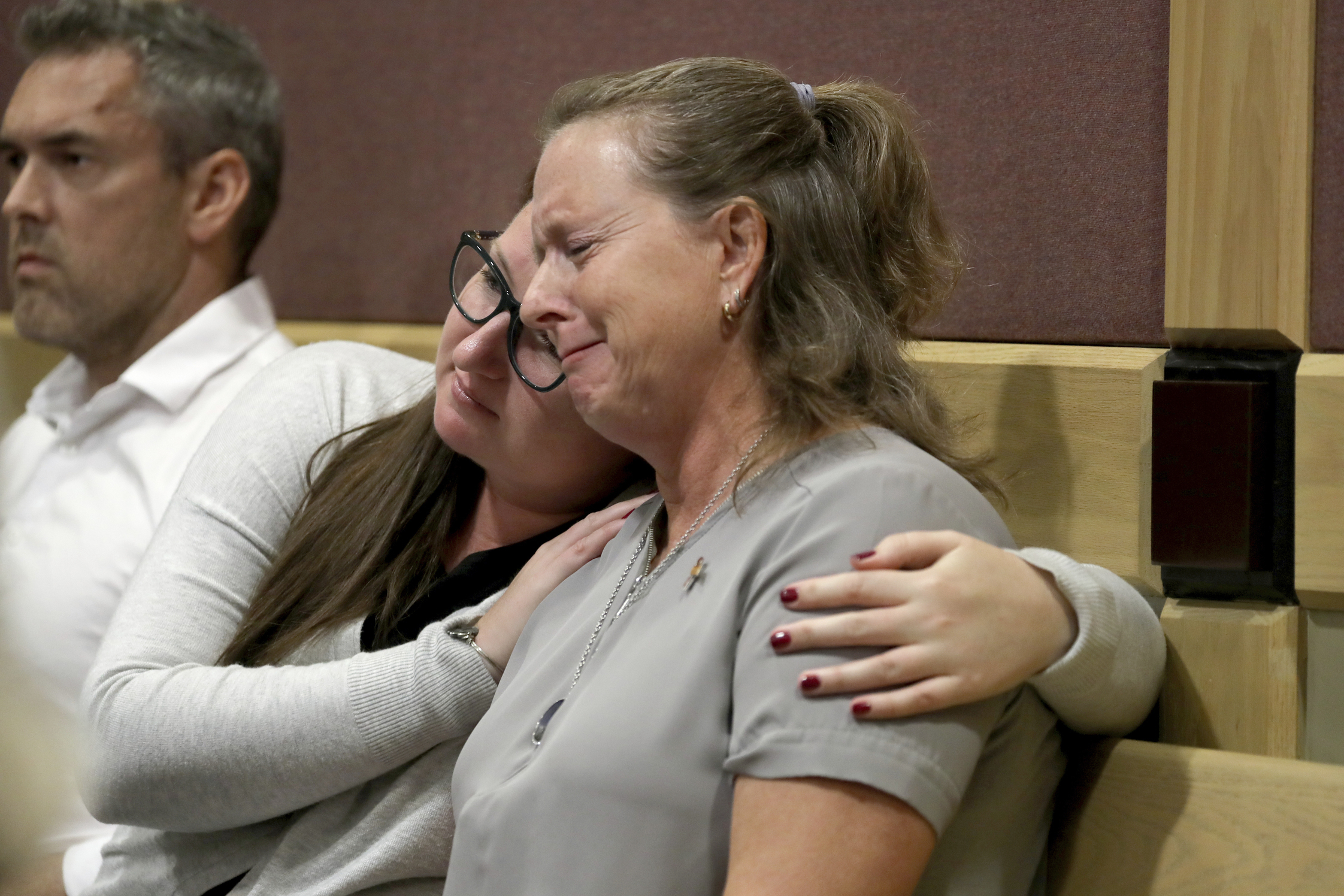 Debbi Hixon, the widow of victim Chris Hixon is consoled in court by close family friend Jennifer Valliere during a hearing for Parkland school shooting suspect Nikolas Cruz. 
