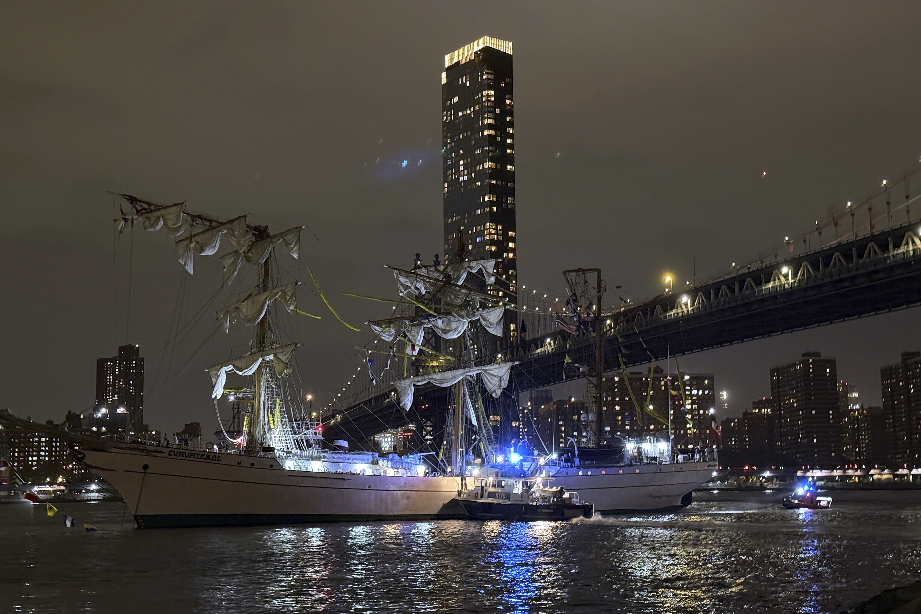 A masted Mexican Navy training ship, the Cuauhtémoc, sits stranded after colliding with the Brooklyn Bridge.