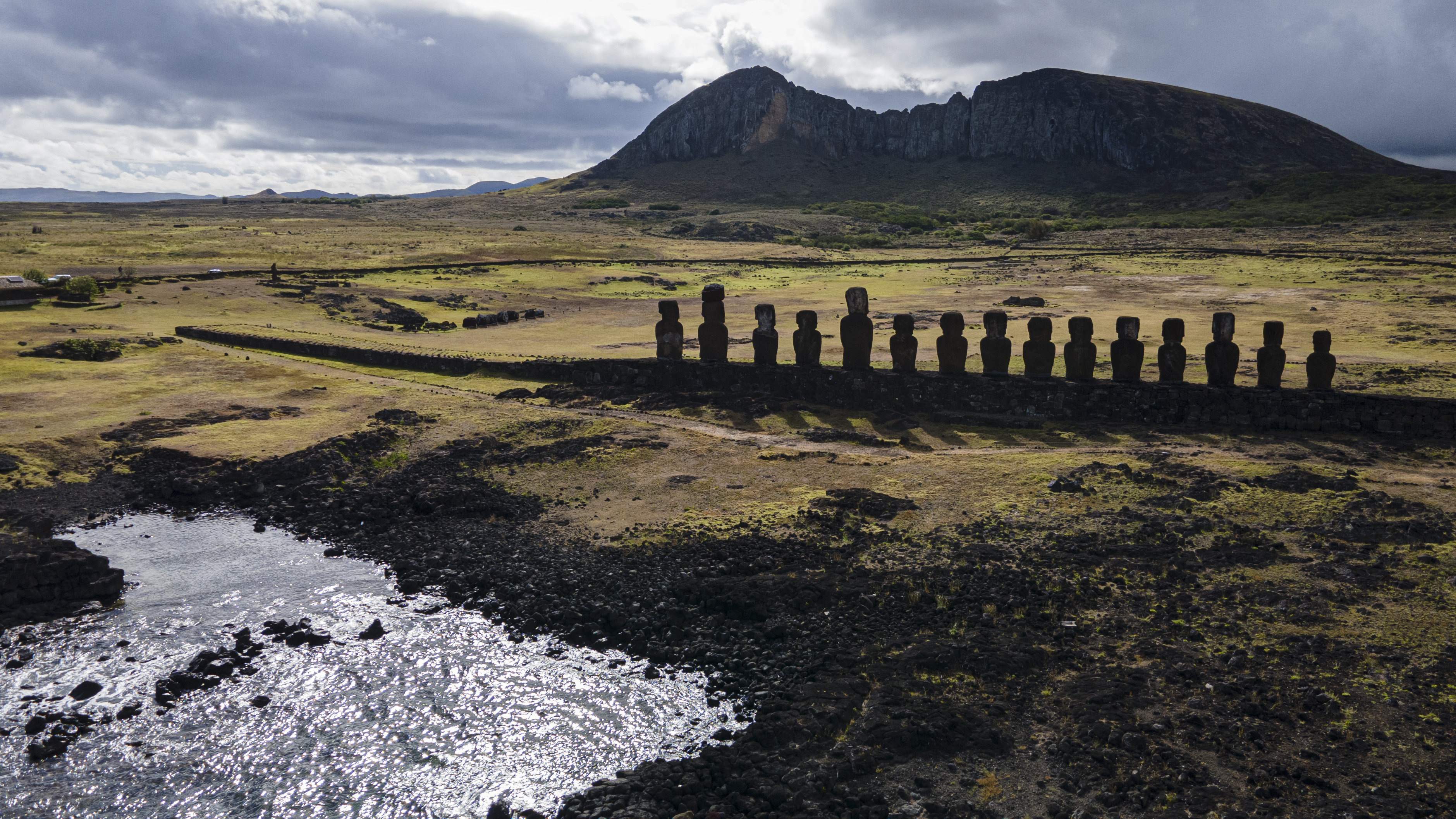 FILE - Moai statues stand on Ahu Tongariki near the Rano Raraku volcano, top, on Rapa Nui, or Easter Island, Chile, Nov. 27, 2022. (AP Photo/Esteban Felix, File)