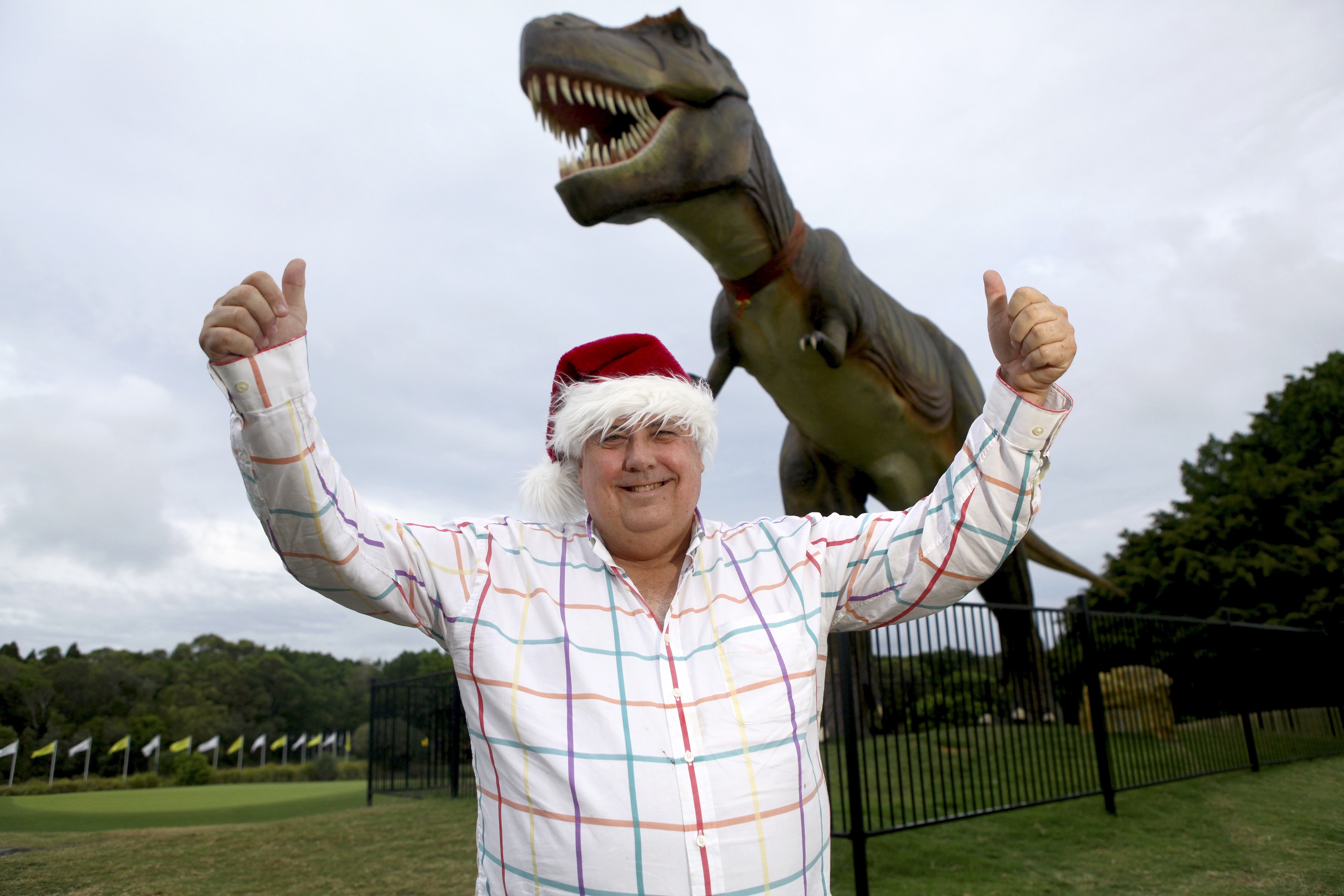 BRISBANE. NEWS. SUN-HERALD. Photograph taken by Michelle Smith on Saturday 22nd December, 2012. Clive Palmer gets into the Christmas spirit with Jeff the dinosaur at the Palmer Coolum Resort where he will host a lunch for 700 people in need on Christmas Day this year.
