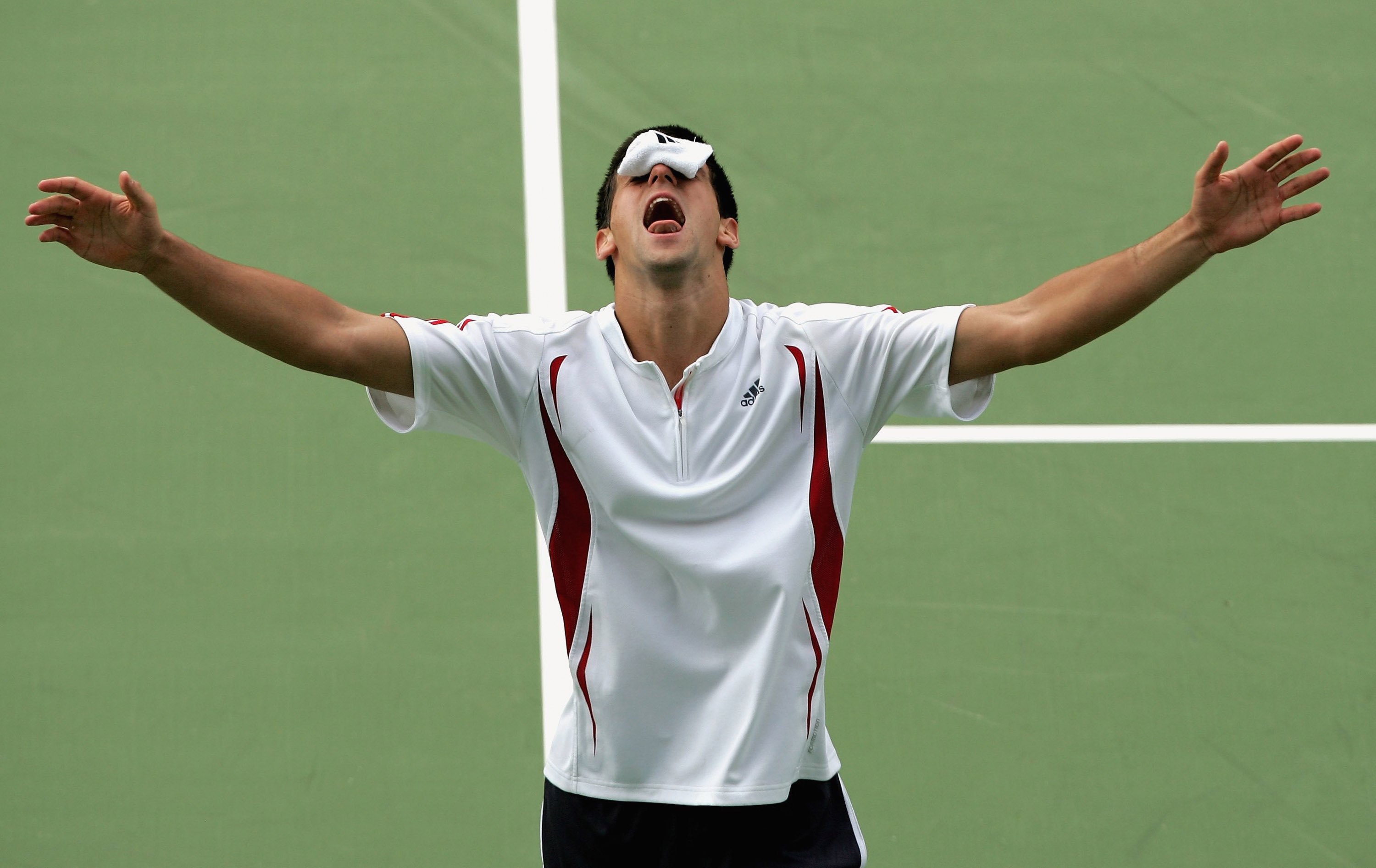 ADELAIDE, AUSTRALIA - JANUARY 07:  Novak Djokovic of Serbia celebrates with a sweatband over his eyes after defeating Chris Guccione of Australia during the final day of the 2007 Next Generation Adelaide International at Memorial Drive on January 7, 2007 in Adelaide, Australia.  (Photo by Mark Dadswell/Getty Images)