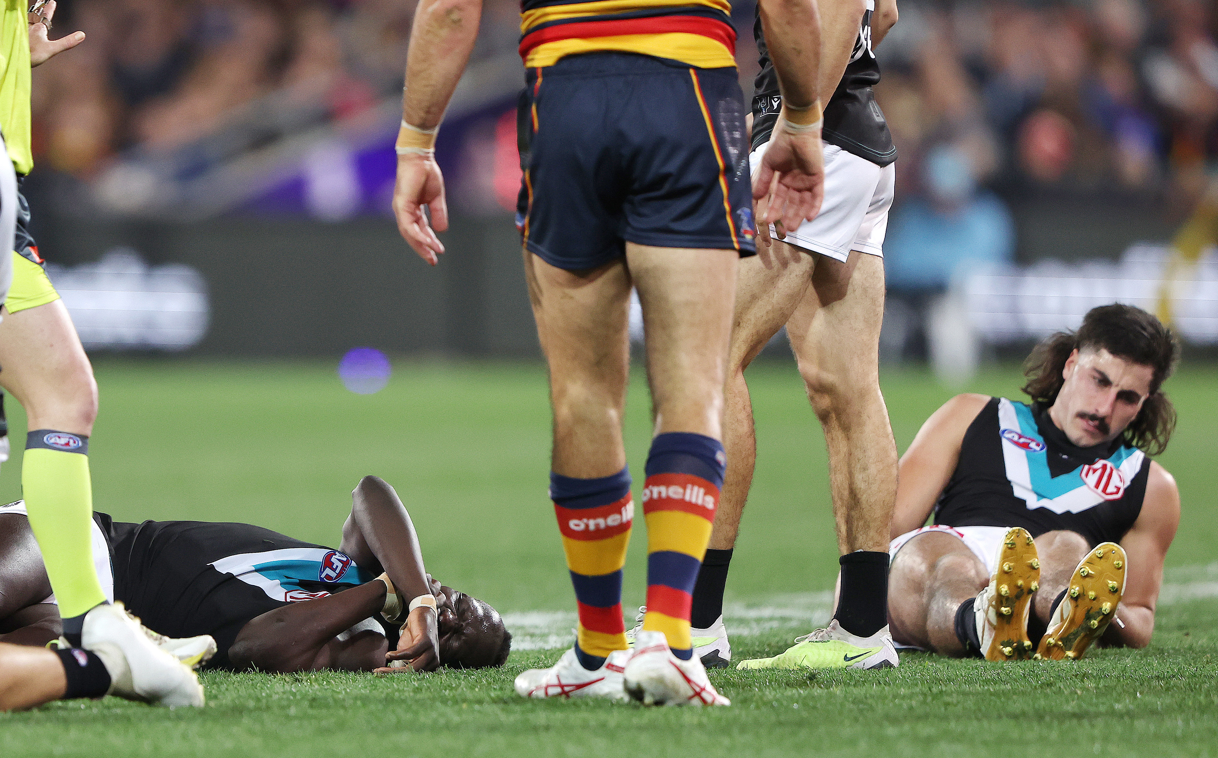ADELAIDE, AUSTRALIA - JULY 29: Aliir Aliir of the Power on the ground along with Lachie Jones of the Power after they collided during the 2023 AFL Round 20 match between the Adelaide Crows and the Port Adelaide Power at Adelaide Oval on July 29, 2023 in Adelaide, Australia. (Photo by Sarah Reed/AFL Photos via Getty Images)