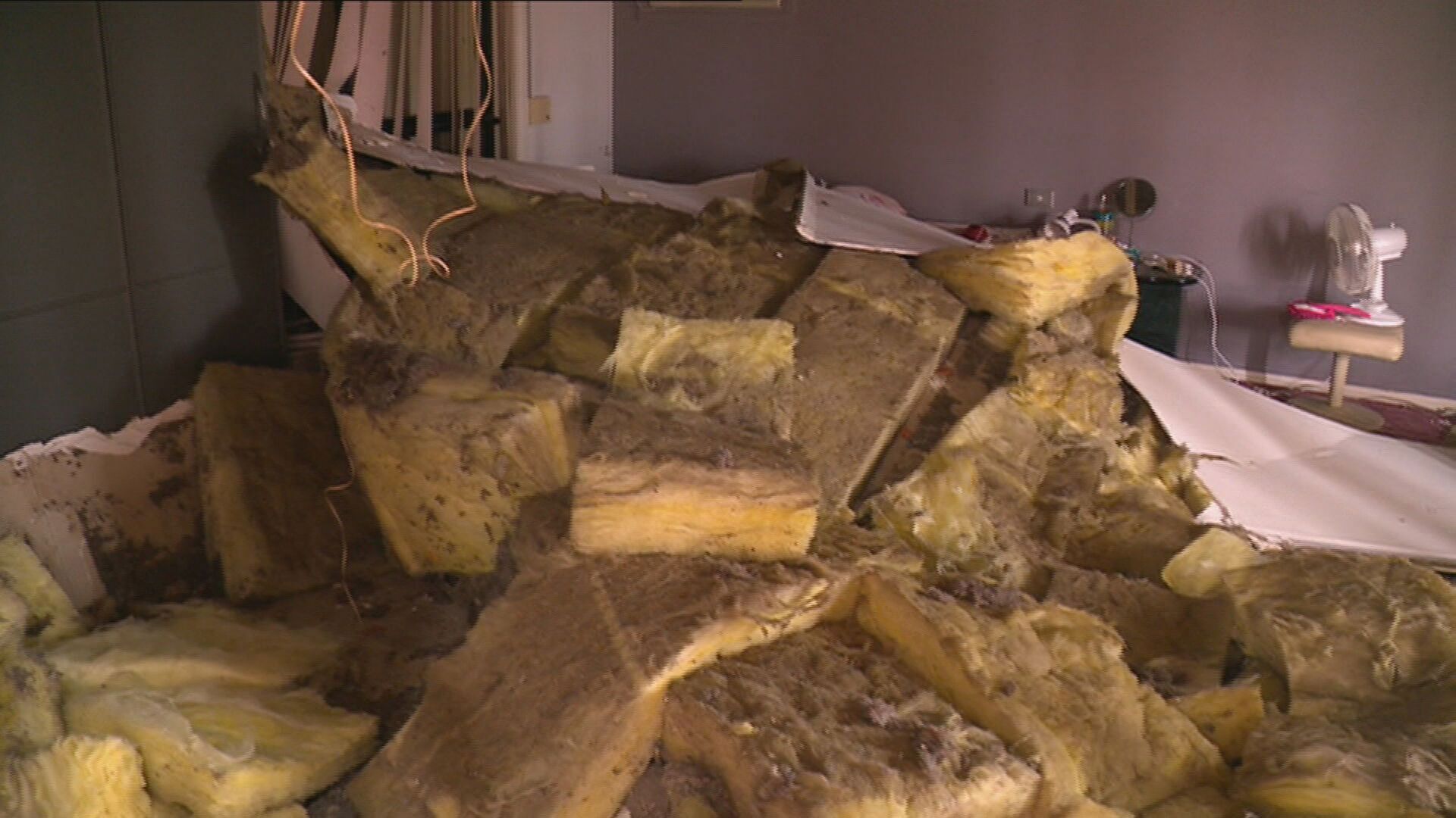 A Melbourne grandmother was trapped under rubble when the roof of her bedroom collapsed.