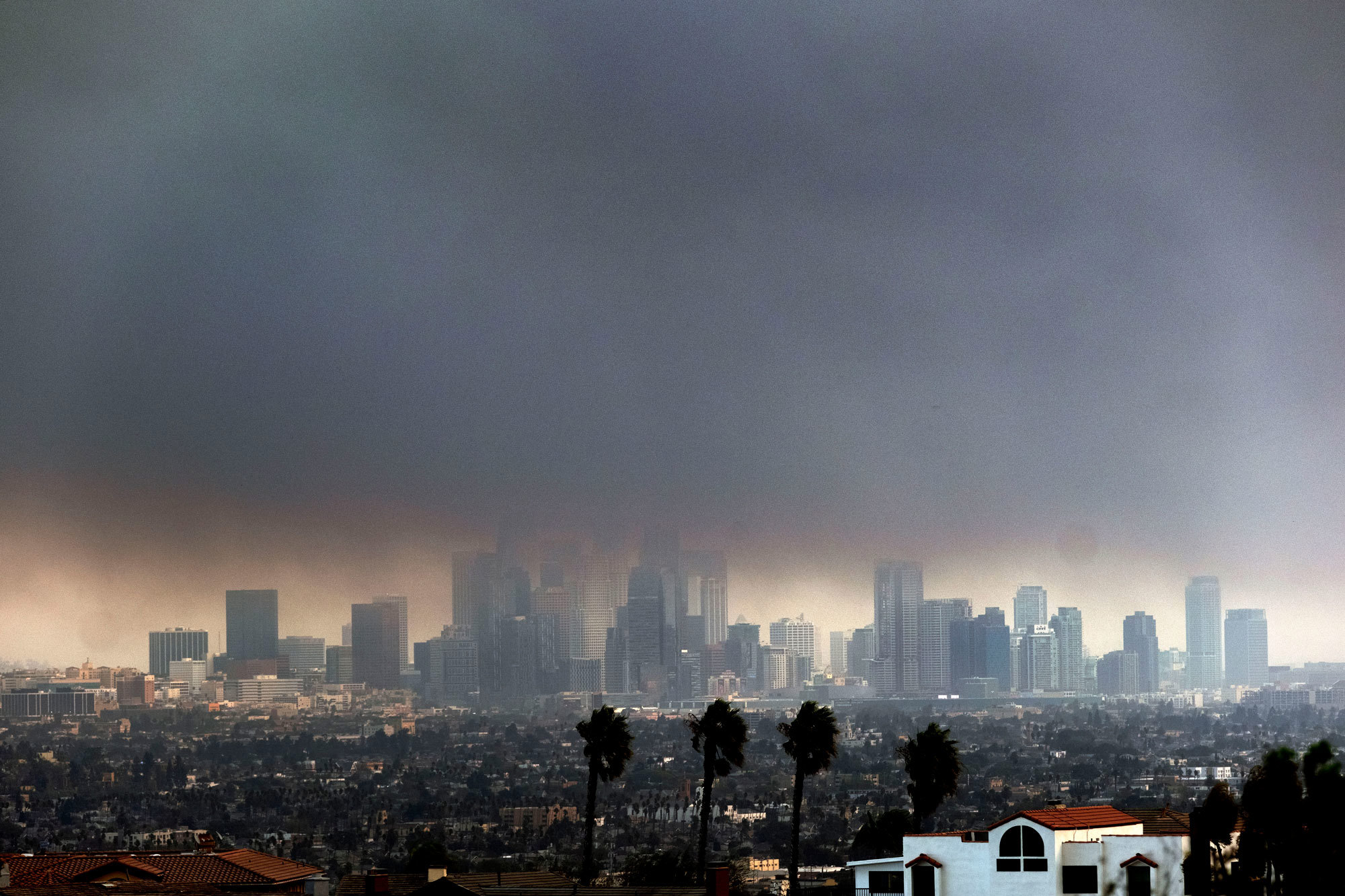 Thick heavy smoke from wildfires shrouds downtown Los Angeles on Wednesday, Jan. 8, 2025.