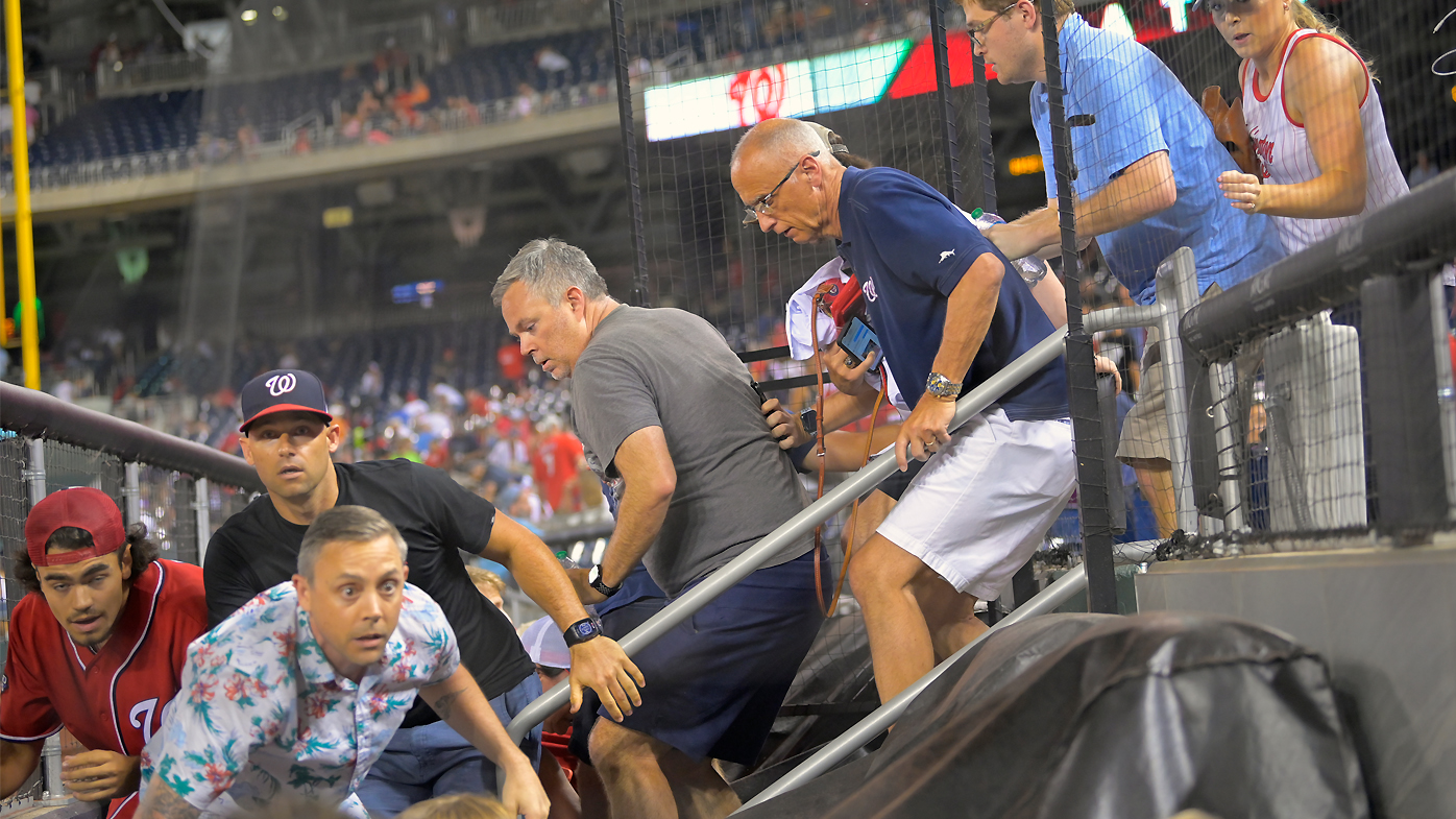  Fans rush to evacuate after hearing during a game between a the San Diego Padres and the Washington Nationals