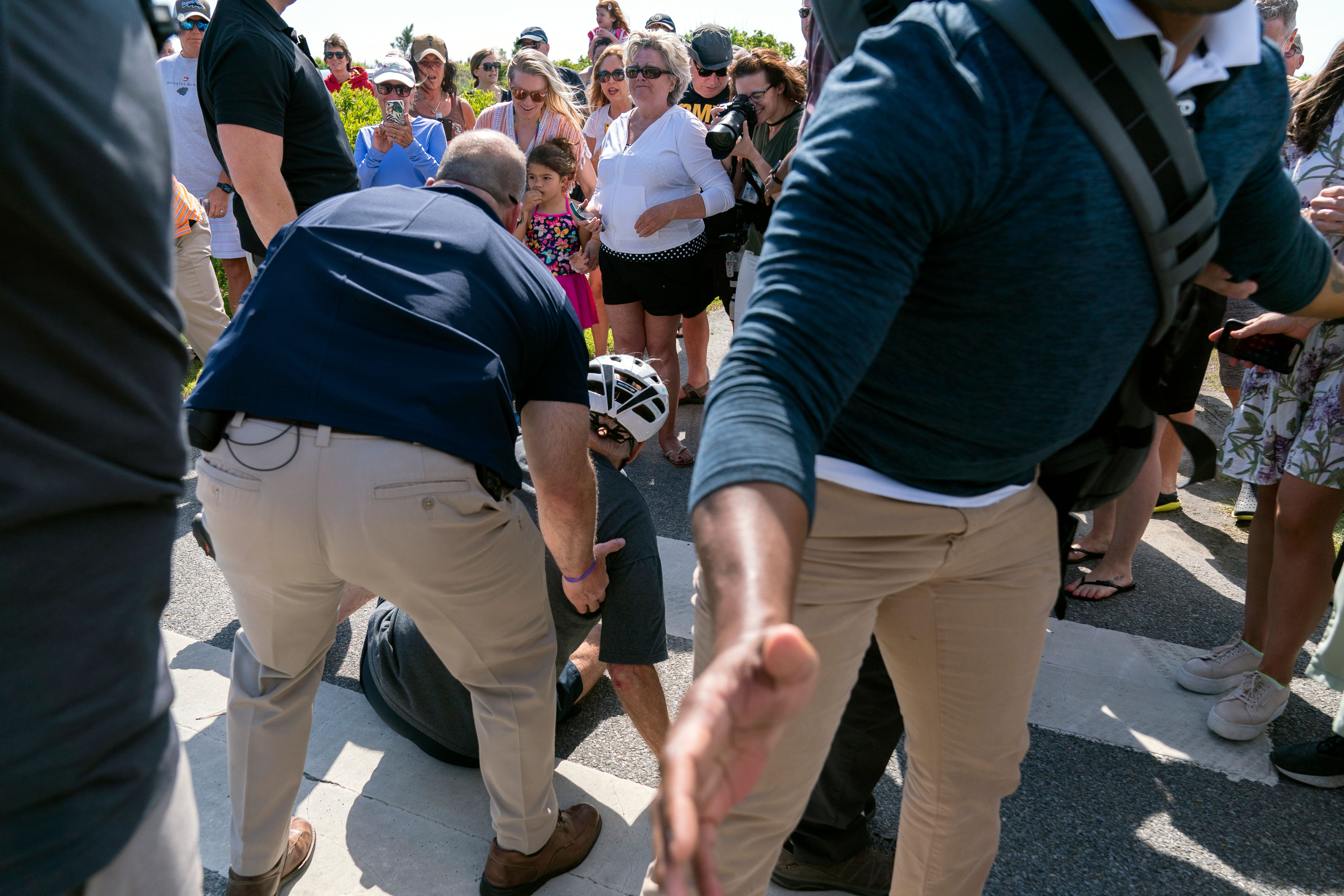 Joe Biden helped up by Secret Service agents after falling off his bike