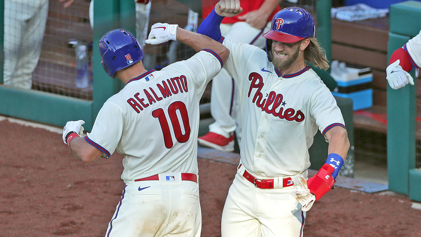 Realmuto #10 of the Philadelphia Phillies celebrates with Bryce Harper #3 after hitting a three-run home run