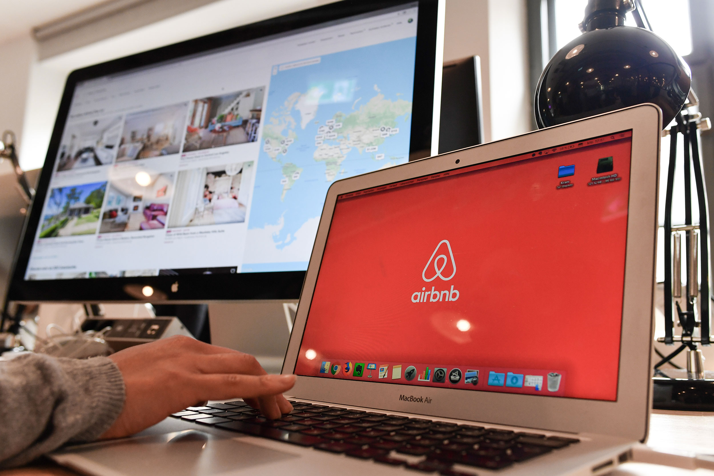 16 April 2018, Germany, Berlin: Airbnb's logo can be seen on different screens in Airbnb Germany GmbH's office in the Neue Schoenhauser Street. Airbnb is a community marketplace for people to book and rent accommodations Private and commercial lessors rent apartments with the support of agencies. Photo: Jens Kalaene/dpa-Zentralbild/dpa (Photo by Jens Kalaene/picture alliance via Getty Images)