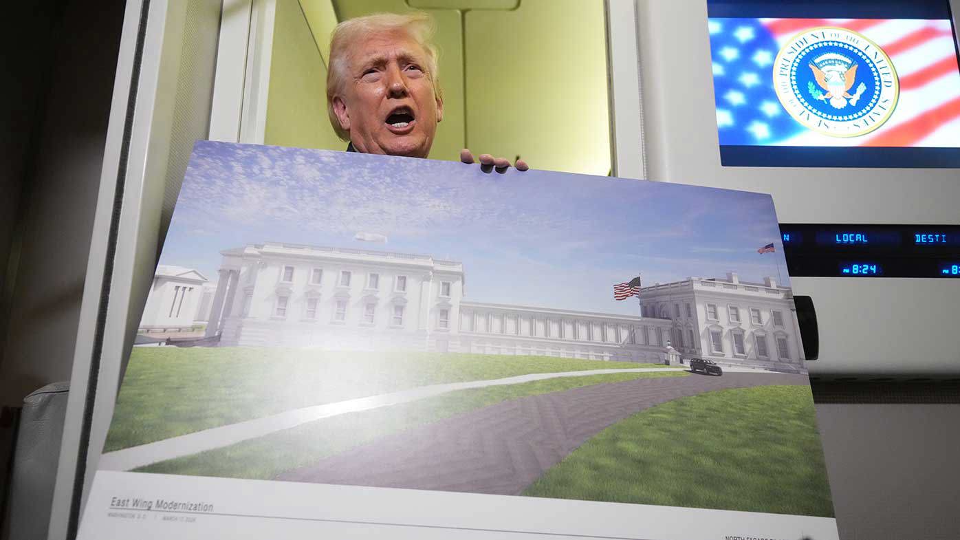 Donald Trump shows off plans for his new White House ballroom while on Air Force One.