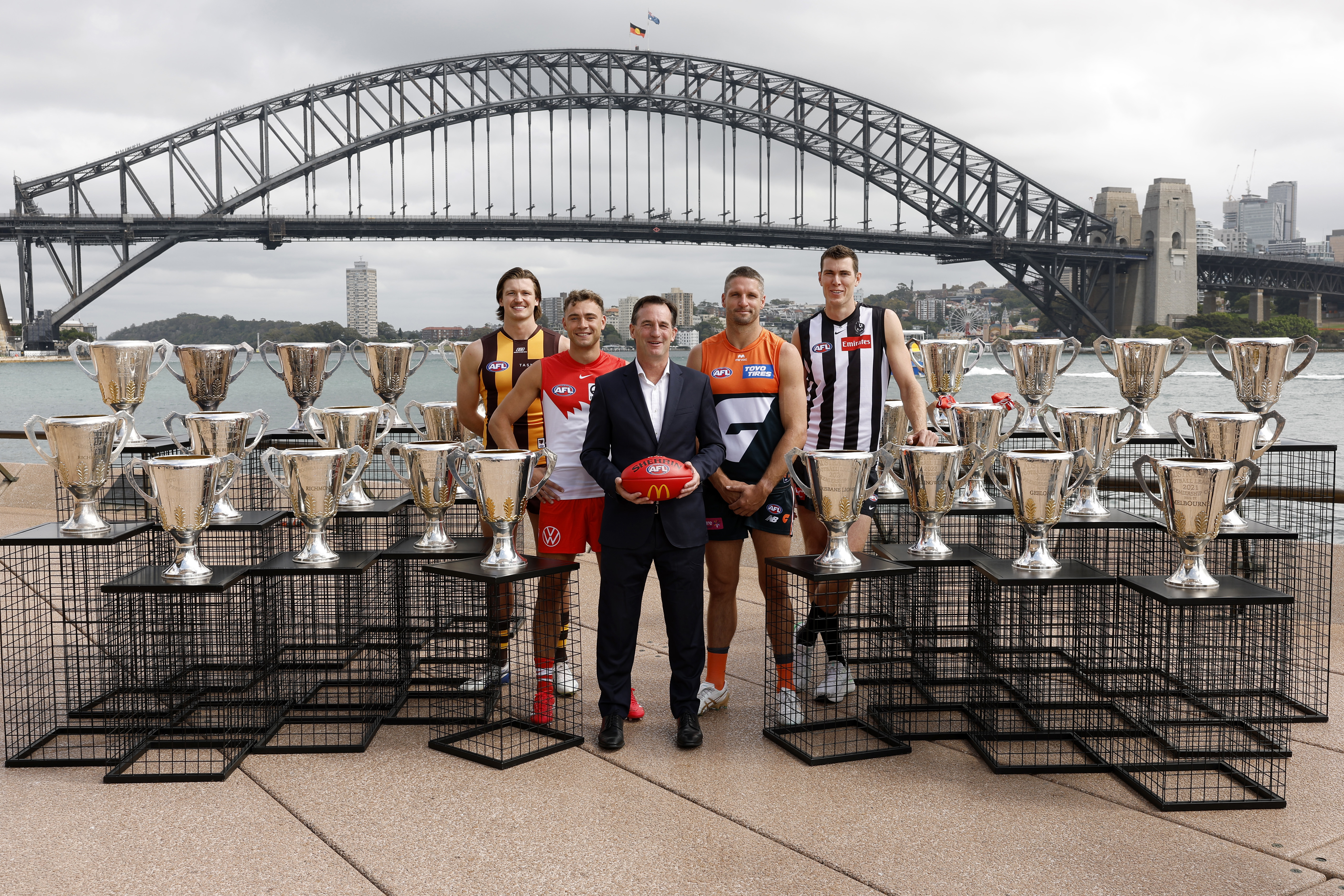 AFL CEO Andrew Dillon poses for a photo with Mitch Lewis of the Hawks, Will Hayward of the Swans, Jesse Hogan of the Giants and Mason Cox of the Magpies during the 2025 AFL Opening Round Launch at Sydney Opera House on March 03, 2025 in Sydney, Australia. (Photo by Darrian Traynor/AFL Photos/via Getty Images)