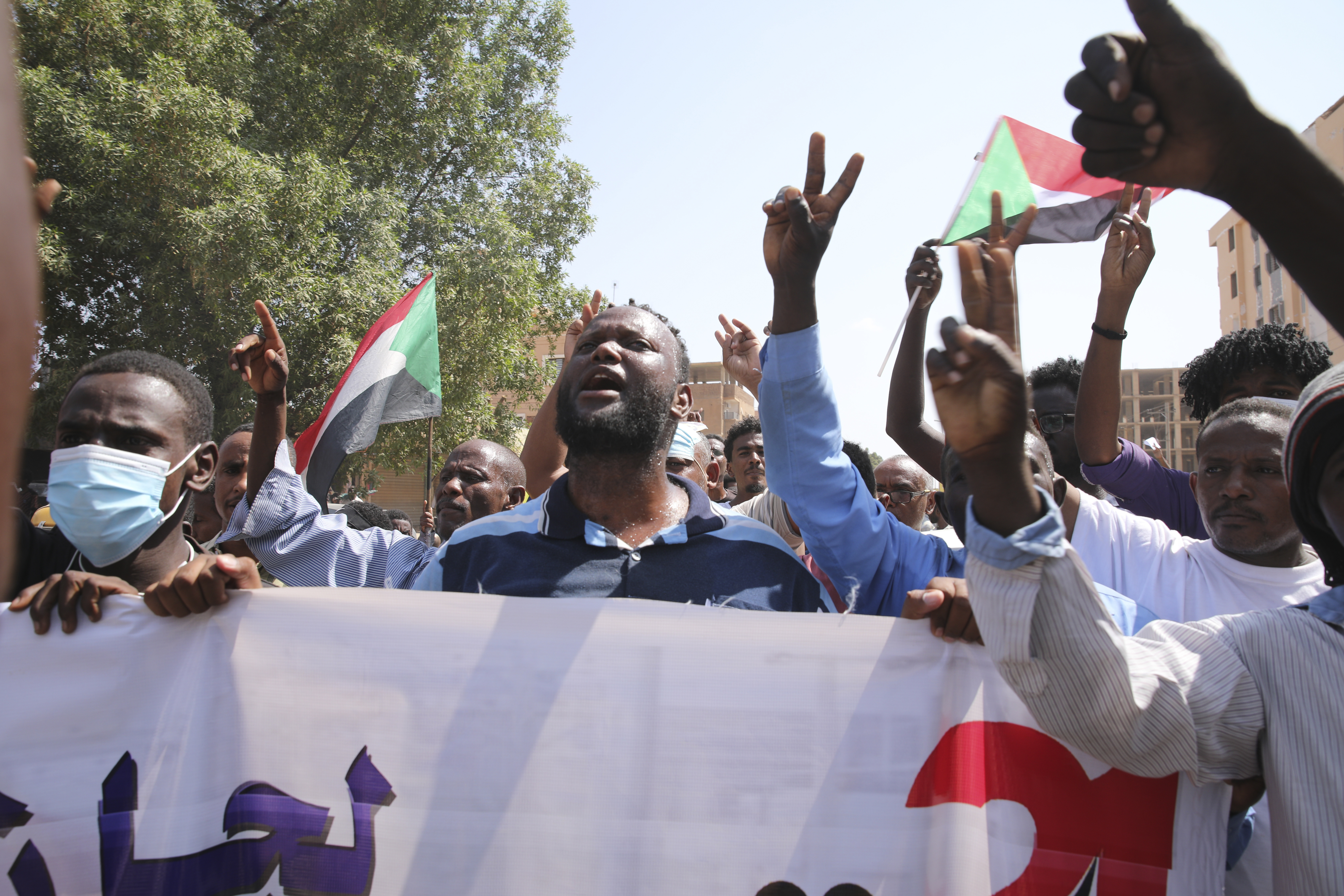 Sudanese demonstrators take to the streets of the capital Khartoum to demand the government's transition to civilian rule in Khartoum, Sudan, Thursday, Oct. 21, 2021. 