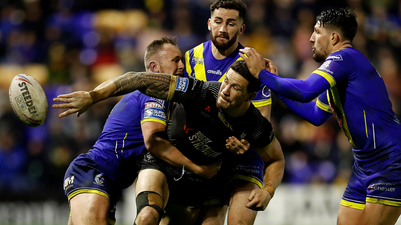Toronto Wolfpack's Sonny Bill Williams is tackled by Warrington Wolves' Ben Currie (left) and Toby King (centre) and Gsareth Widdop (right)