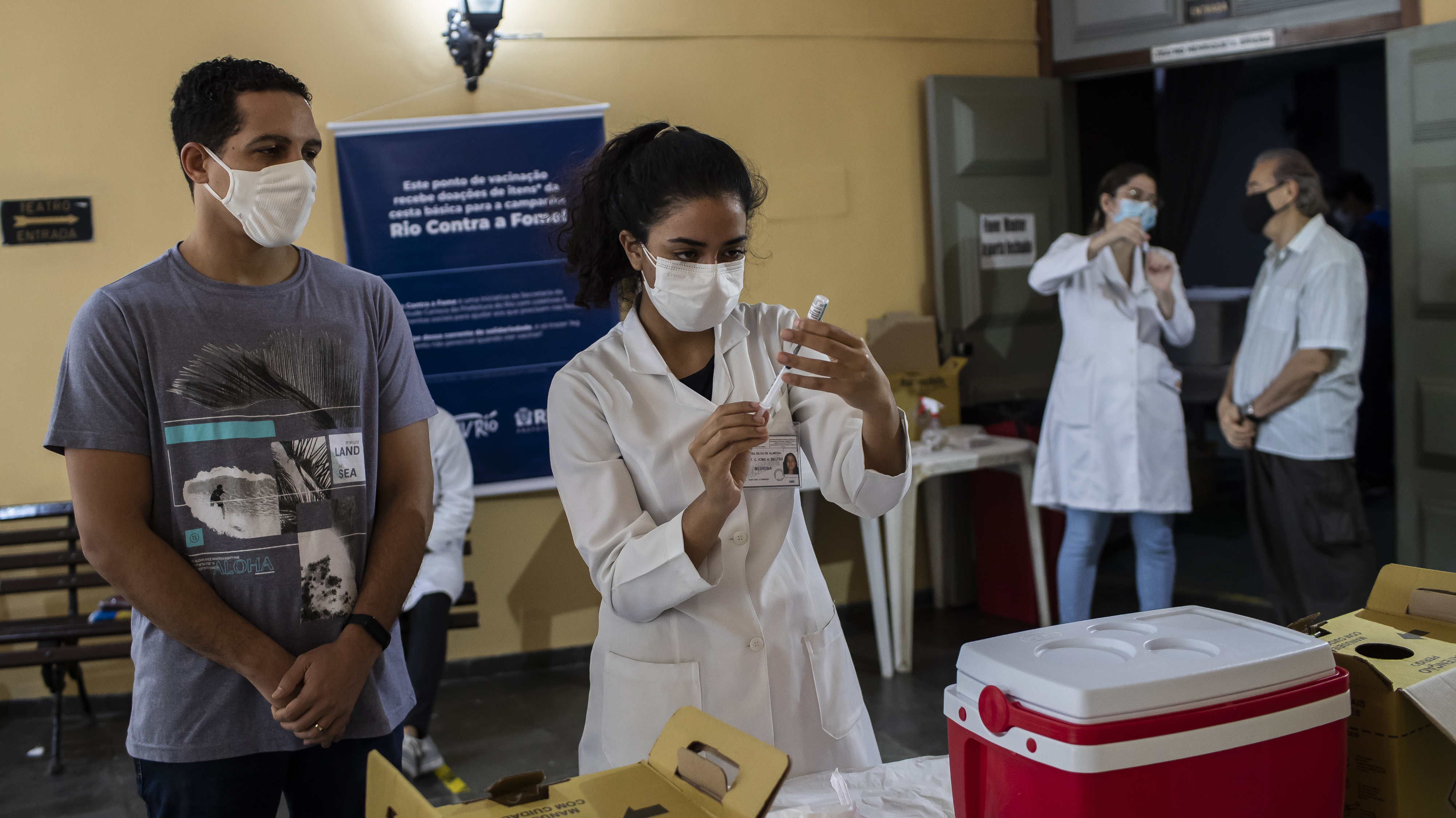 A health worker prepares a shot of the AstraZeneca vaccine for COVID-19 during a vaccination campaign for people over age 35 in Rio de Janeiro