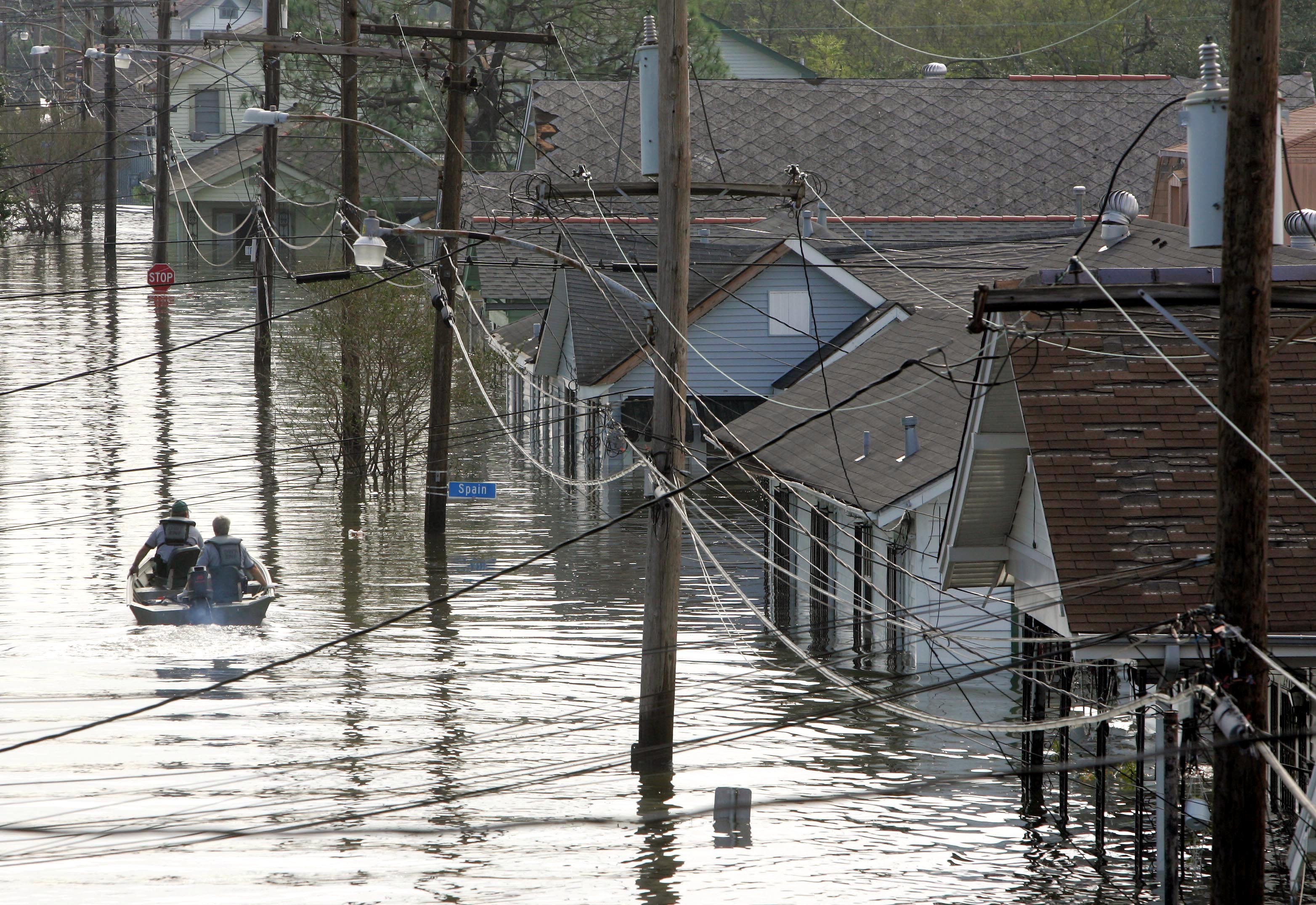 FILE - In this Tuesday, Aug. 30, 2005 file photo, Rescue personnel search from victims as they traverse the New Orleans 8th Ward in the flooded city of New Orleans. Water continues to rise after the onslaught of Hurricane Katrina. Hurricane Ida looks an awful lot like Hurricane Katrina, bearing down on the same part of Louisiana on the same calendar date. But hurricane experts say there are differences in the two storms 16 years apart that may prove key and may make Ida nastier in some ways but 
