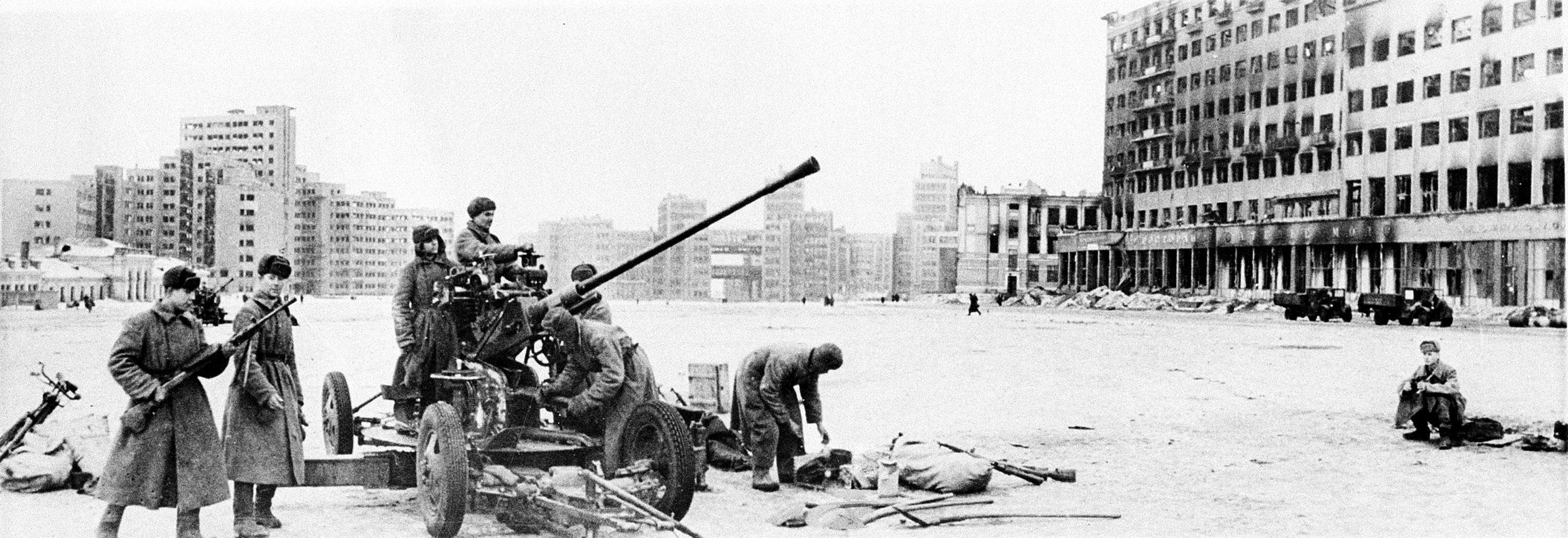 Soviet troops man an anti-aircraft gun in one of the squares of Kharkov, Ukraine steel center, after the Red Army retake the city from the Germans in Feb. 1943 during World War II. The House of Industry is in the background. (AP Photo)