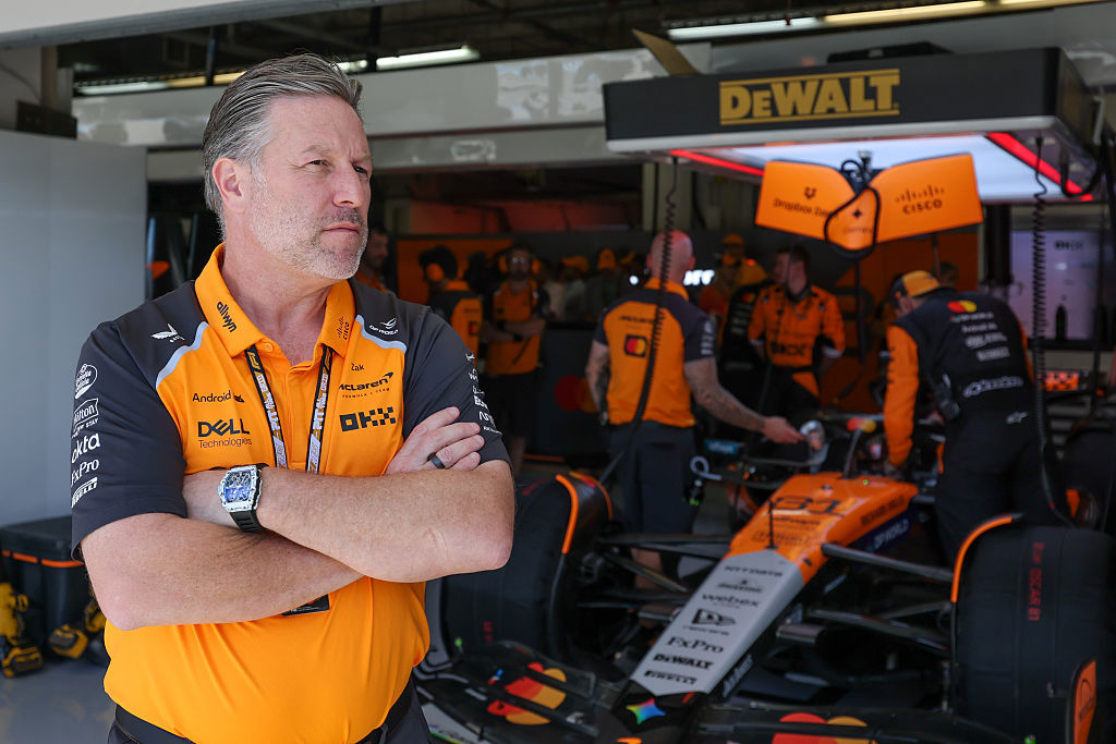 Zak Brown stands in front of the garage of McLaren Formula 1 Team driver Oscar Piastri.