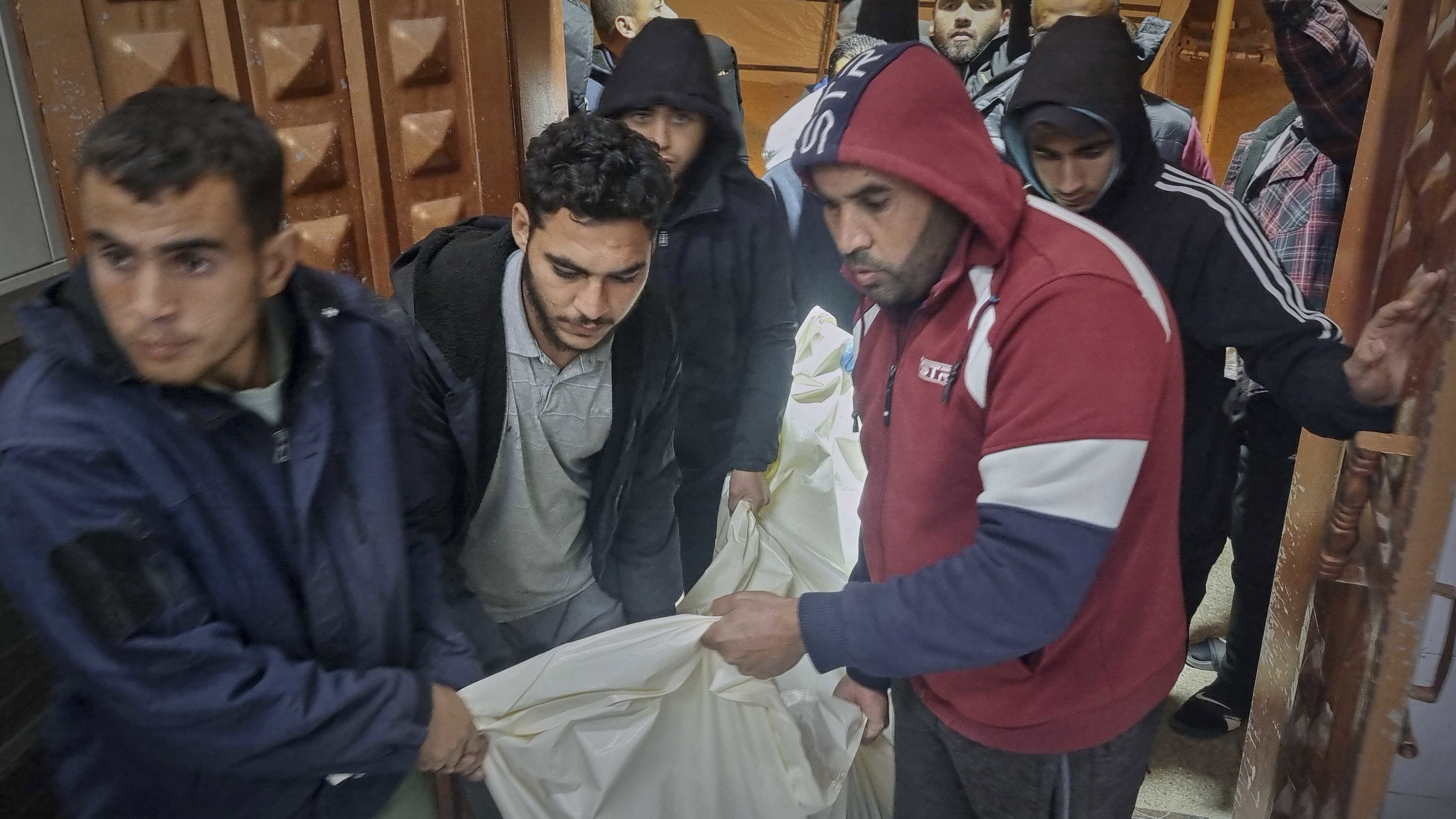 A dead person killed during an Israeli army strike is taken into the hospital in Khan Younis, southern Gaza Strip, Tuesday March 18, 2025.