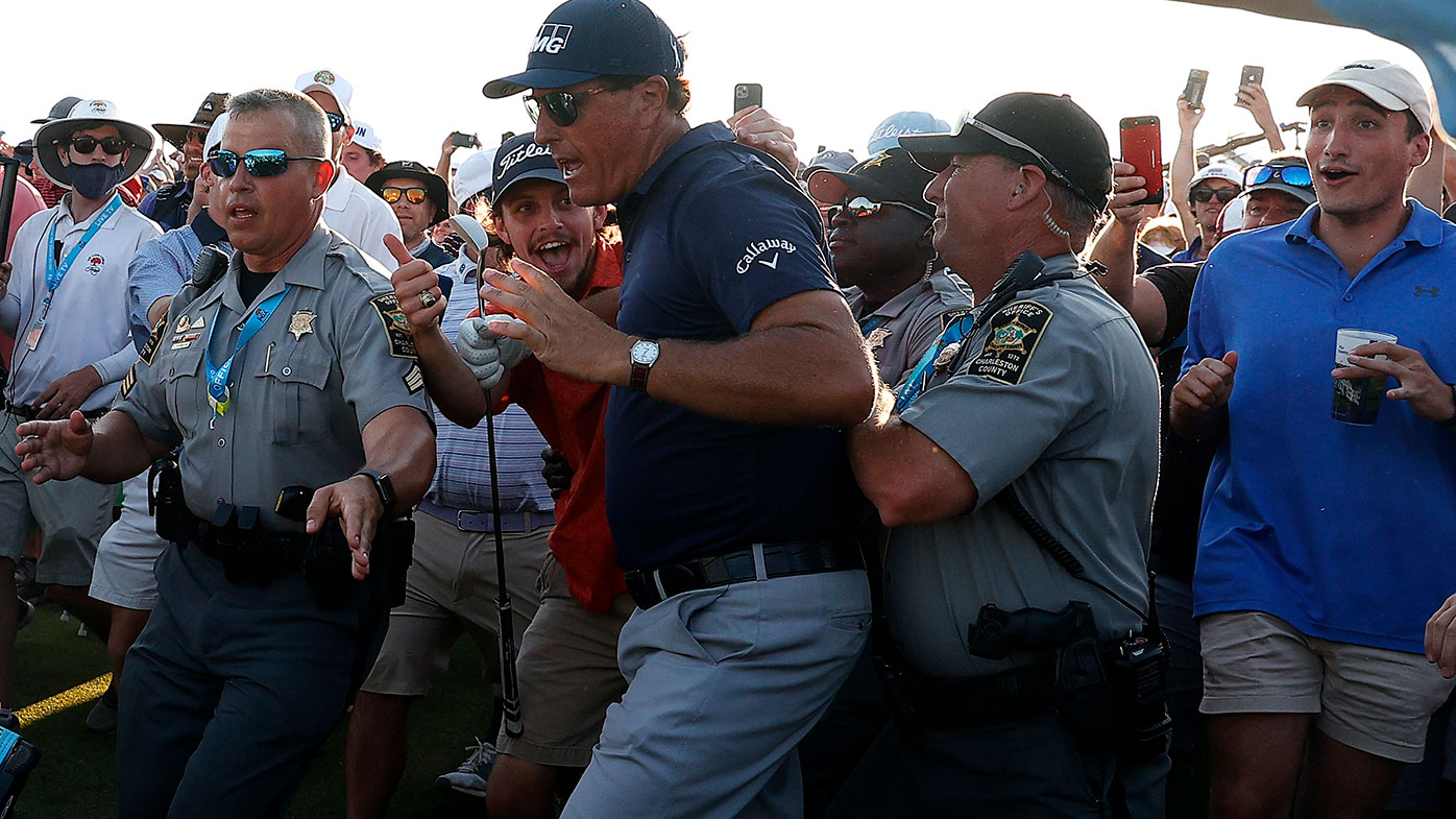 Phil Mickelson fights his way through the crowd on the final hole of the PGA Championship at Kiawah Island.