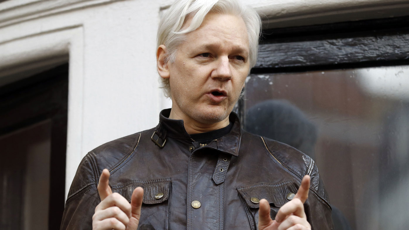 In this May 19, 2017, file photo, WikiLeaks founder Julian Assange gestures to supporters outside the Ecuadorian embassy in London, where he has been in self imposed exile since 2012. 