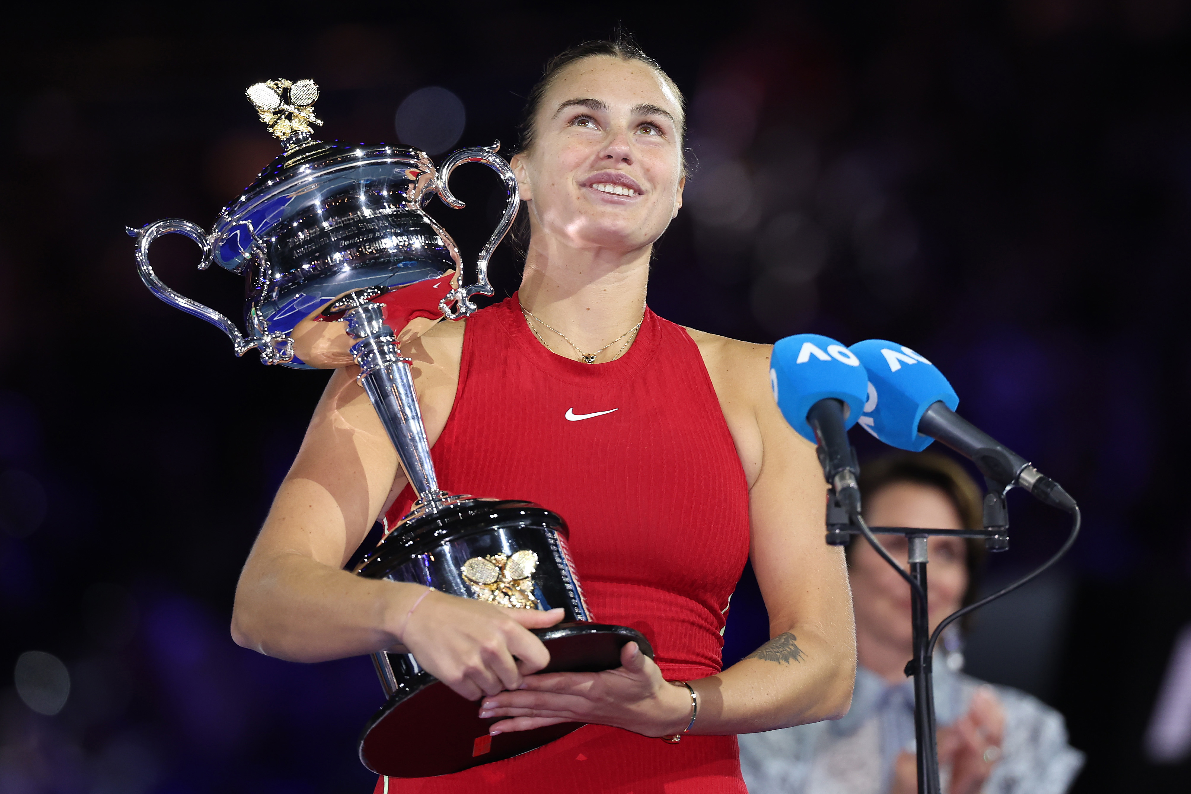 MELBOURNE, AUSTRALIA - JANUARY 27: Aryna Sabalenka holds the Daphne Akhurst Memorial Cup during the official presentation after the the Women's Singles Final match between Qinwen Zheng of China and Aryna Sabalenka during the 2024 Australian Open at Melbourne Park on January 27, 2024 in Melbourne, Australia. (Photo by Cameron Spencer/Getty Images)