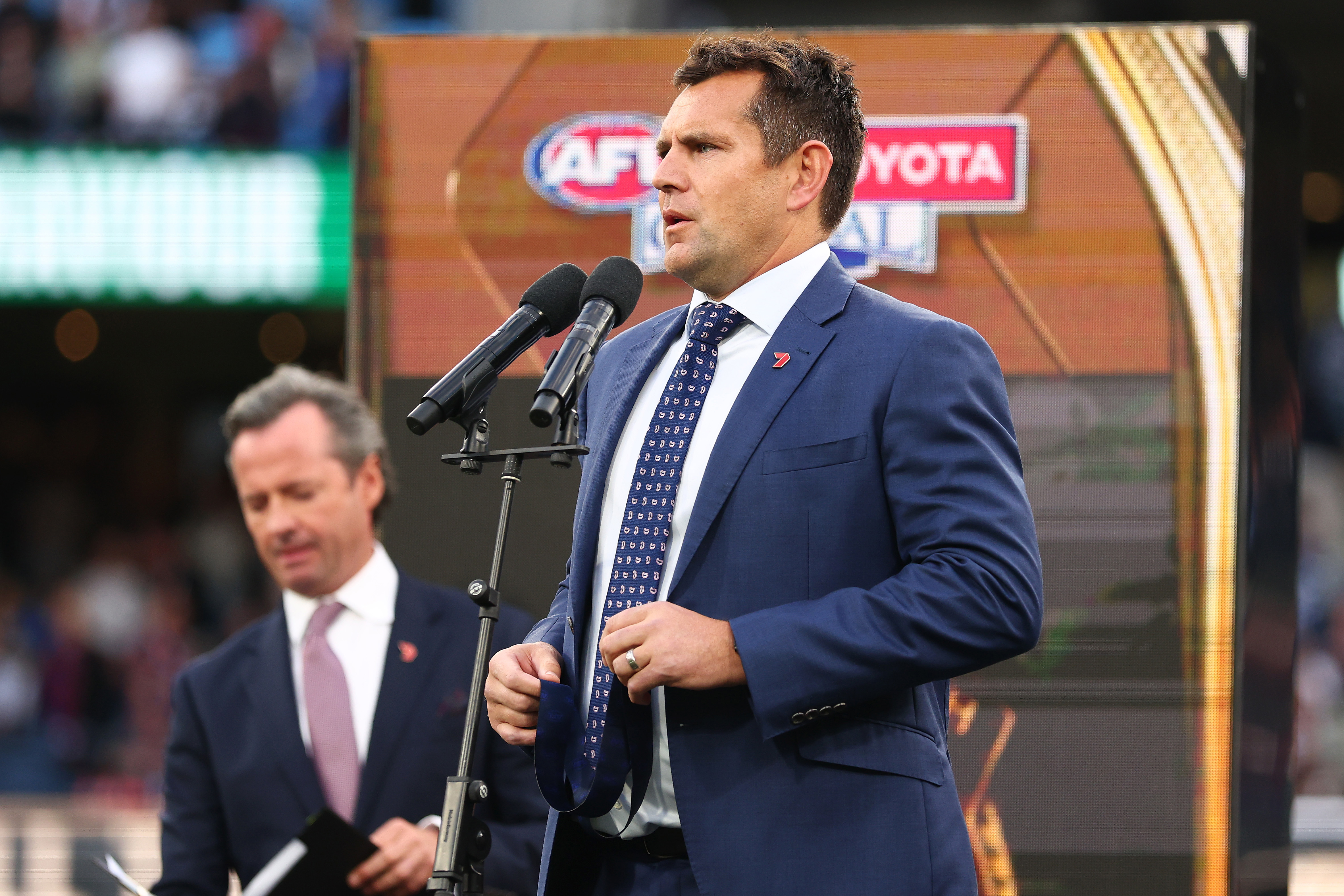 Luke Hodge presents the Norm Smith Medal in 2025.
