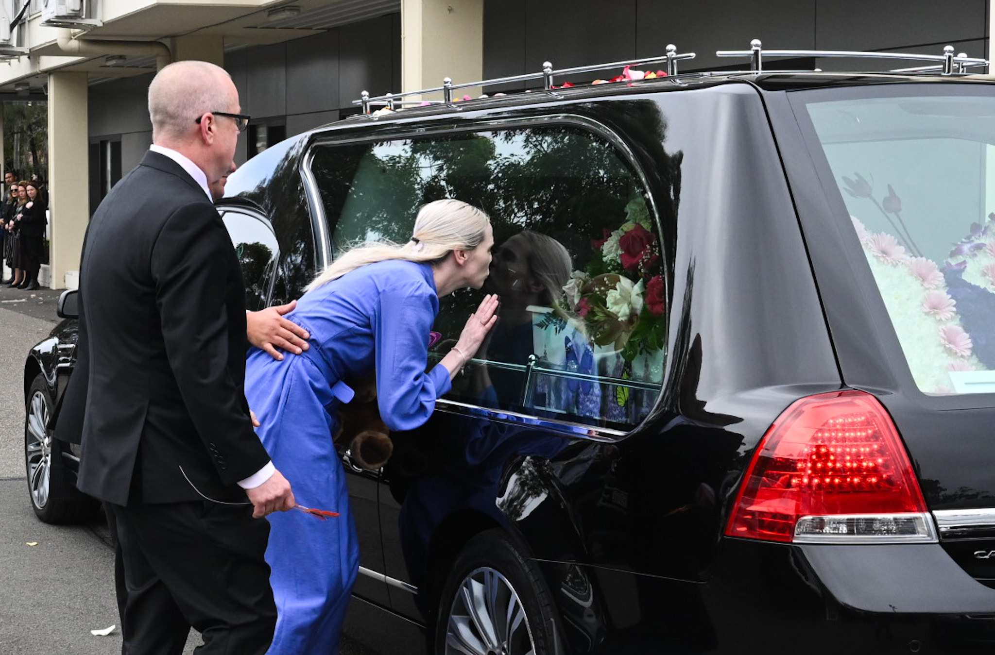 Charlotte's parents farewell a hearse carrying her coffin.