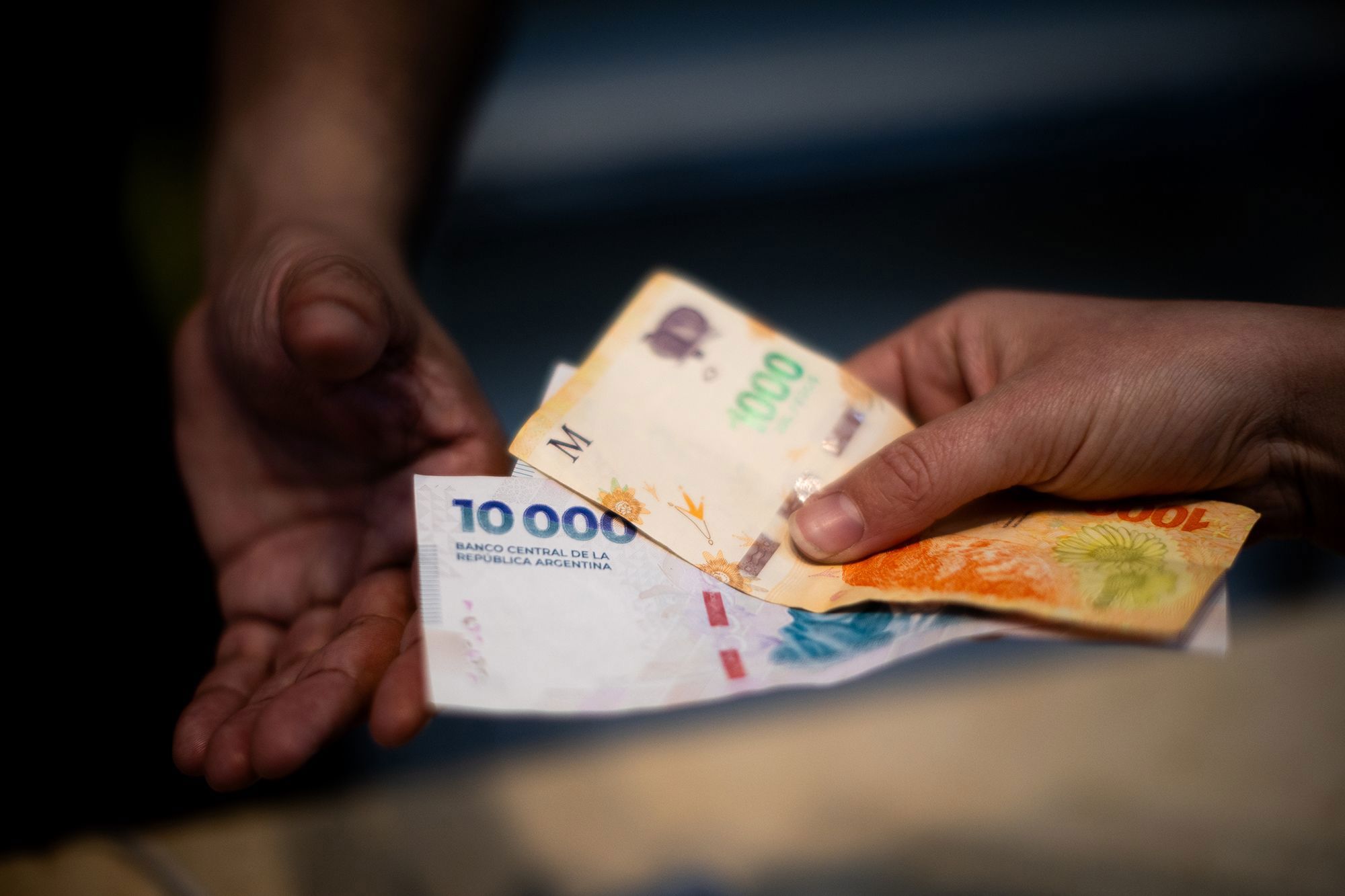 A customer pays for food with Argentine peso banknotes in the financial district of Buenos Aires, Argentina, on September 8.