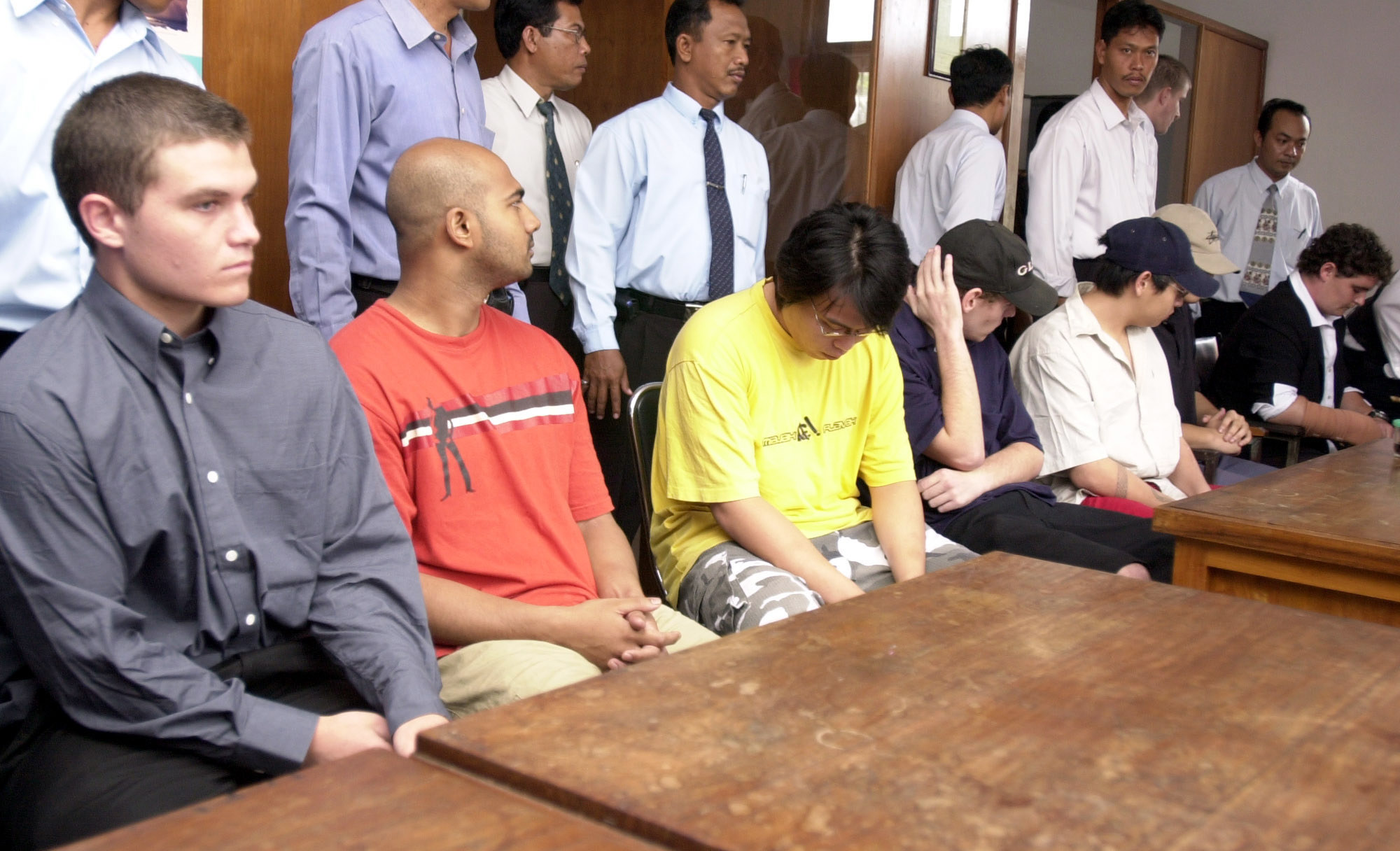 Seven of nine Australian drug smuggling suspects, from left to right, Scott Rush, Myuran Sukumaran, Tanduc Tan Nguyen, Matthew Norman, Andrew Chan, Si Yi Chan and Renae Lawrence sit att he prosecutors office in Denpasar, Bali, Indonesia, Monday, Aug. 15, 2005. Police have handed over their case filed to the prosecutors office, indicating that the nine could go on trial in the coming weeks. (AP Photo/Firdia Lisnawati)