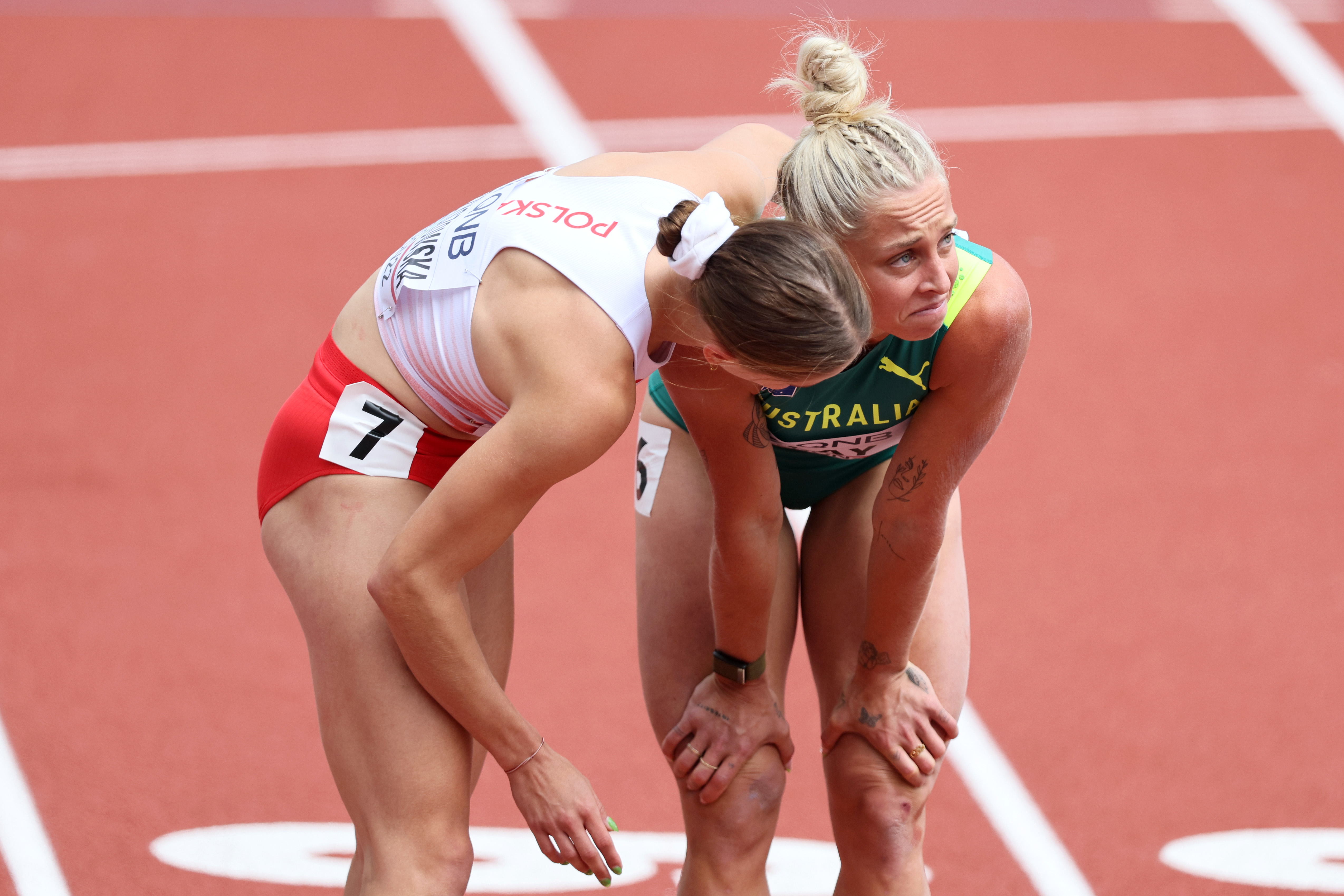 Liz Clay is consoled by Poland's Pia Skrzyszowska after injuring her foot.