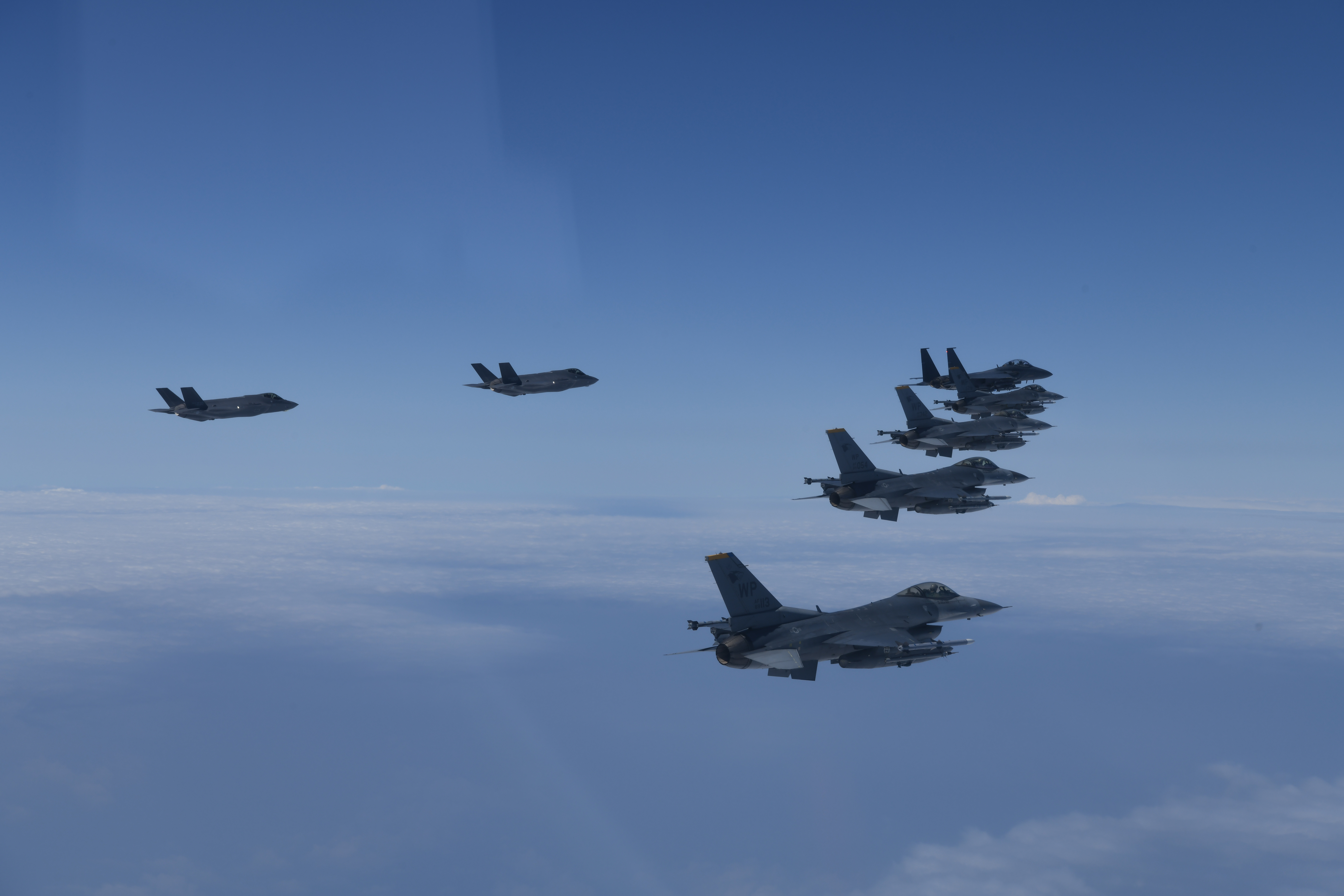 In this photo provided by South Korea Defense Ministry, U.S. and South Korea Air Force fighter jets fly in formation during a joint drill on Tuesday, June, 7, 2022. The South Korean and U.S. militaries flew 20 fighter jets over South Korea's western sea Tuesday in a continued show of force as a senior U.S. official warned of a forceful response if North Korea goes ahead with its first nuclear test explosion in nearly five years. 