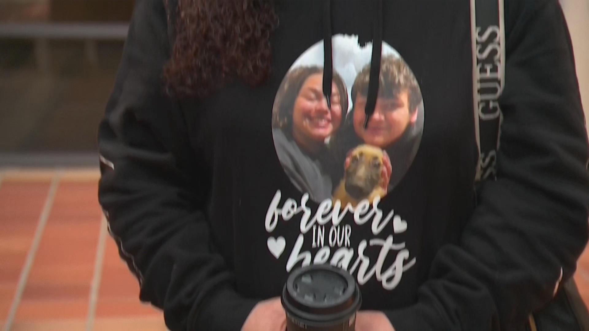 Angelina Kauffman was overcome with emotion when she exited the courthouse, wearing a jumper bearing a photo of her children.