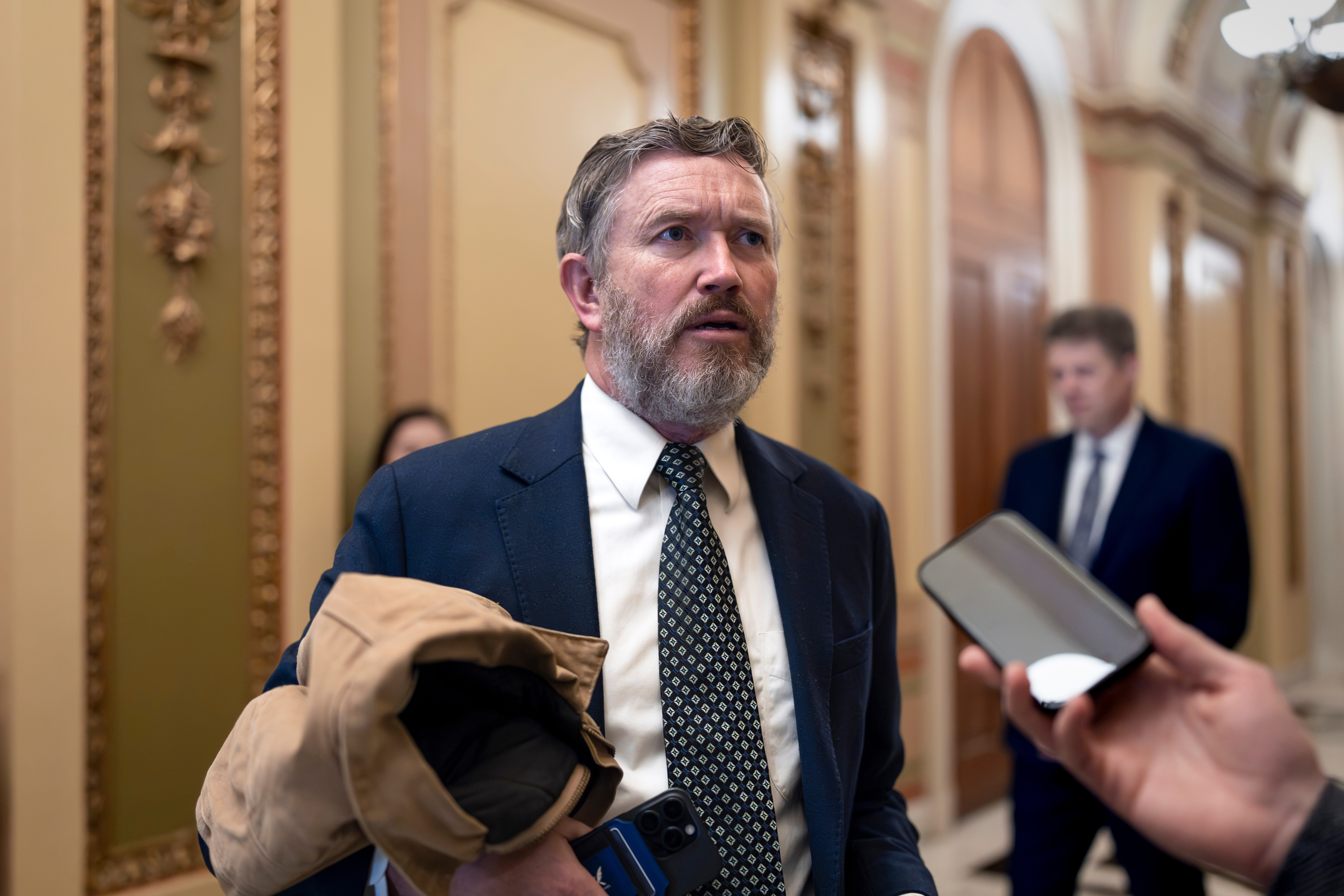 Rep. Thomas Massie, R-Ky., speaks outside the House chamber before the final votes of the week, at the Capitol in Washington, Friday, Dec. 12, 2025. (AP Photo/J. Scott Applewhite)