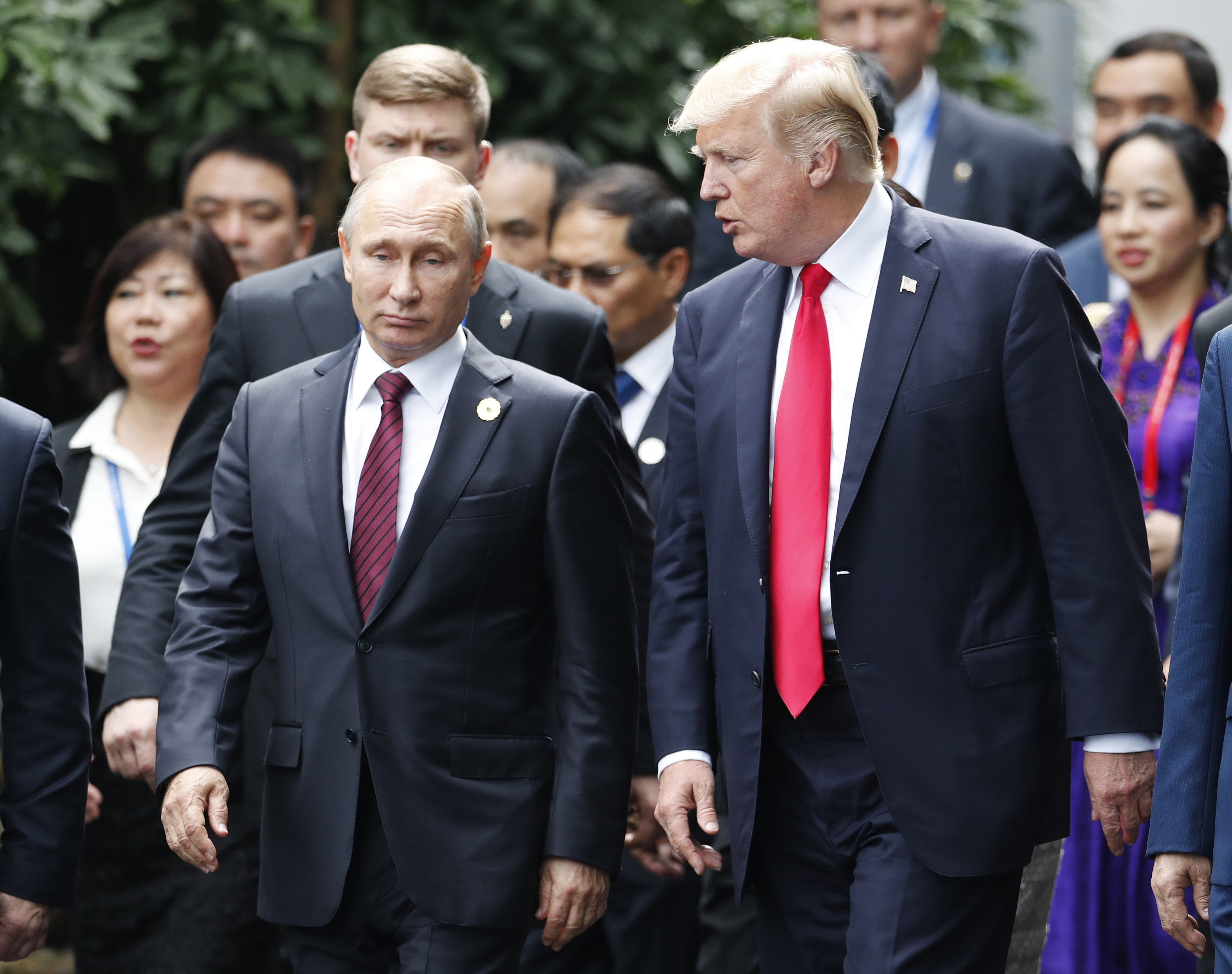 U.S. President Donald Trump, right, and Russia's President Vladimir Putin talk during the family photo session at the APEC Summit in Danang, Vietnam Saturday, Nov. 11, 2017. Trump and Putin may not be having a formal meeting while theyre in Vietnam for an economic summit. But the two appear to be chumming it up nonetheless. Snippets of video from the Asia-Pacific Economic Cooperation conference Saturday have shown the leaders chatting and shaking hands at events including a world leaders group p