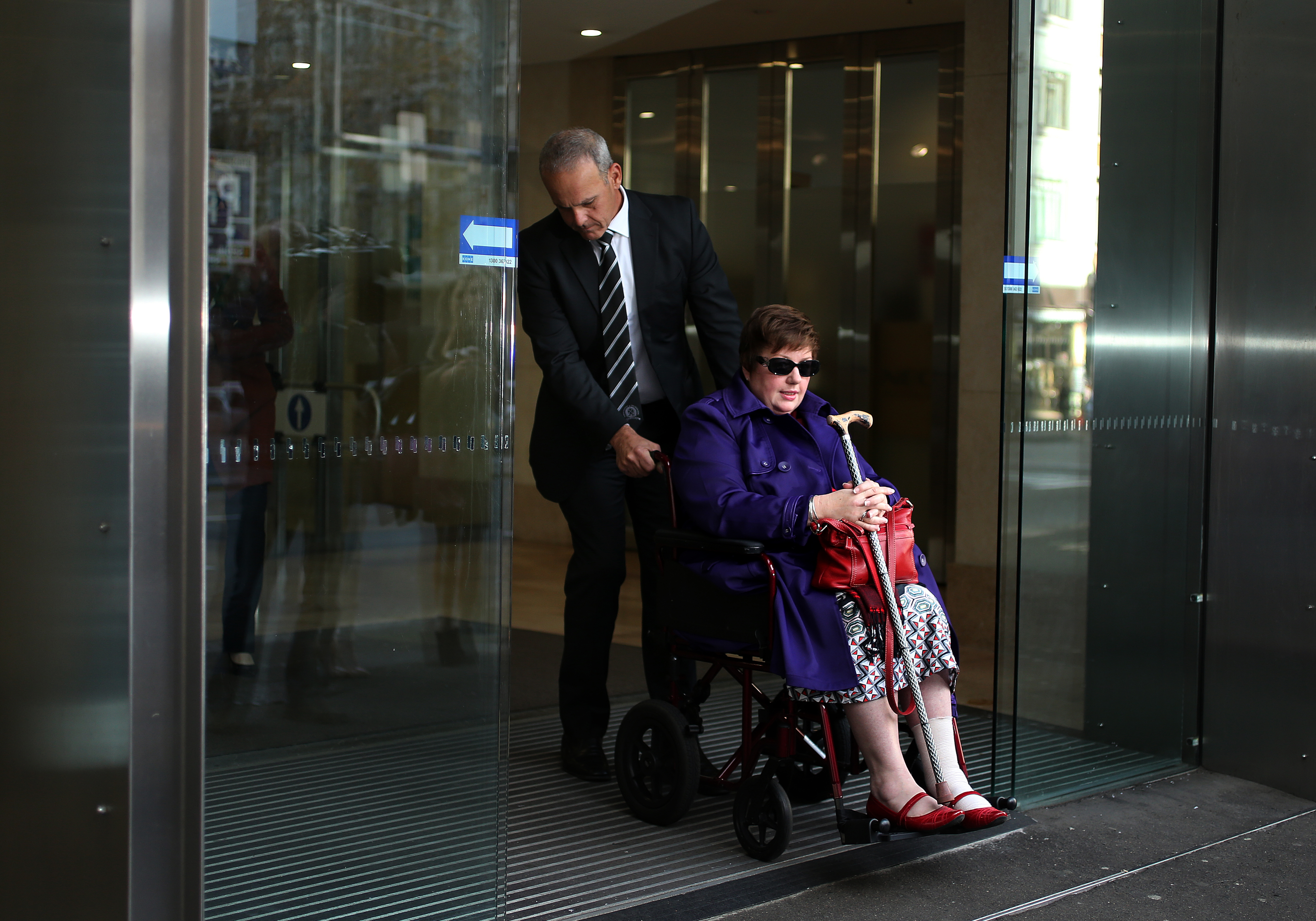 Detective Inspector Angelo Memmolo (left) who is heading the critical incident investigation into the Martin Place siege with hostage survivor Louisa Hope (right) leaves the John Maddison Tower where the inquest into the siege is taking place in Sydney. 27th May, 2015. Photo: Kate Geraghty