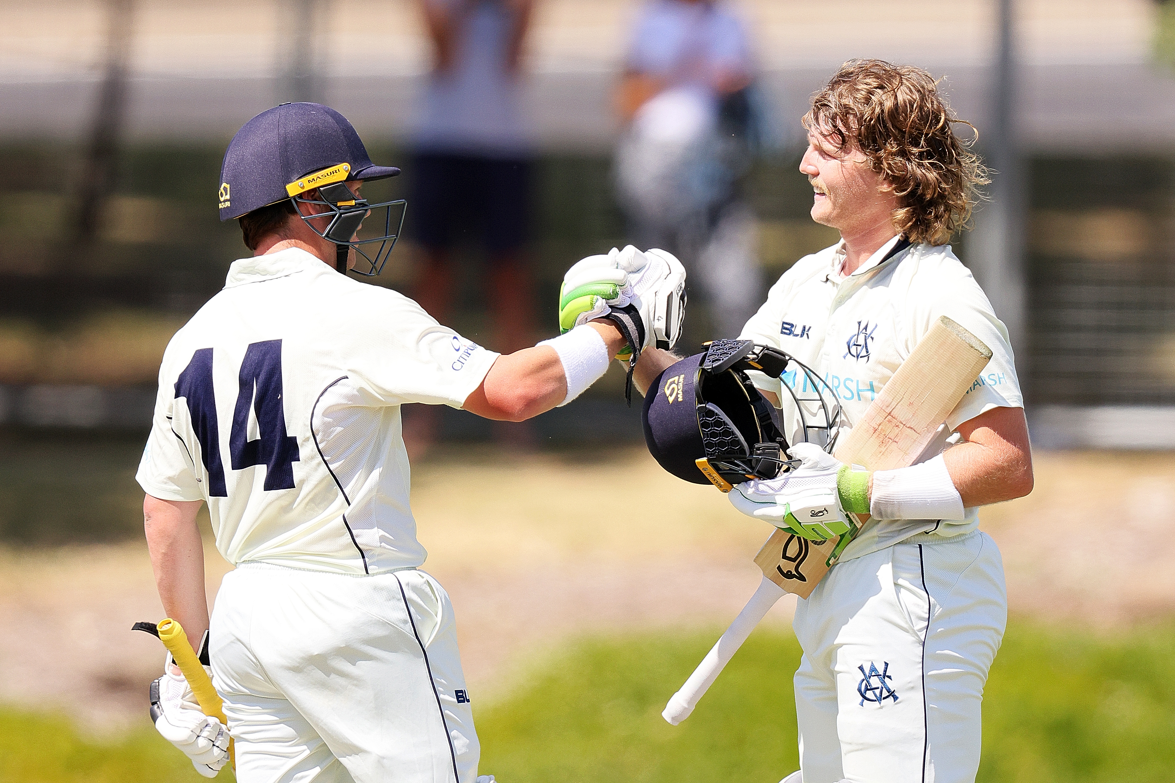 Marcus Harris congratulates Will Pucovski on reaching his century.