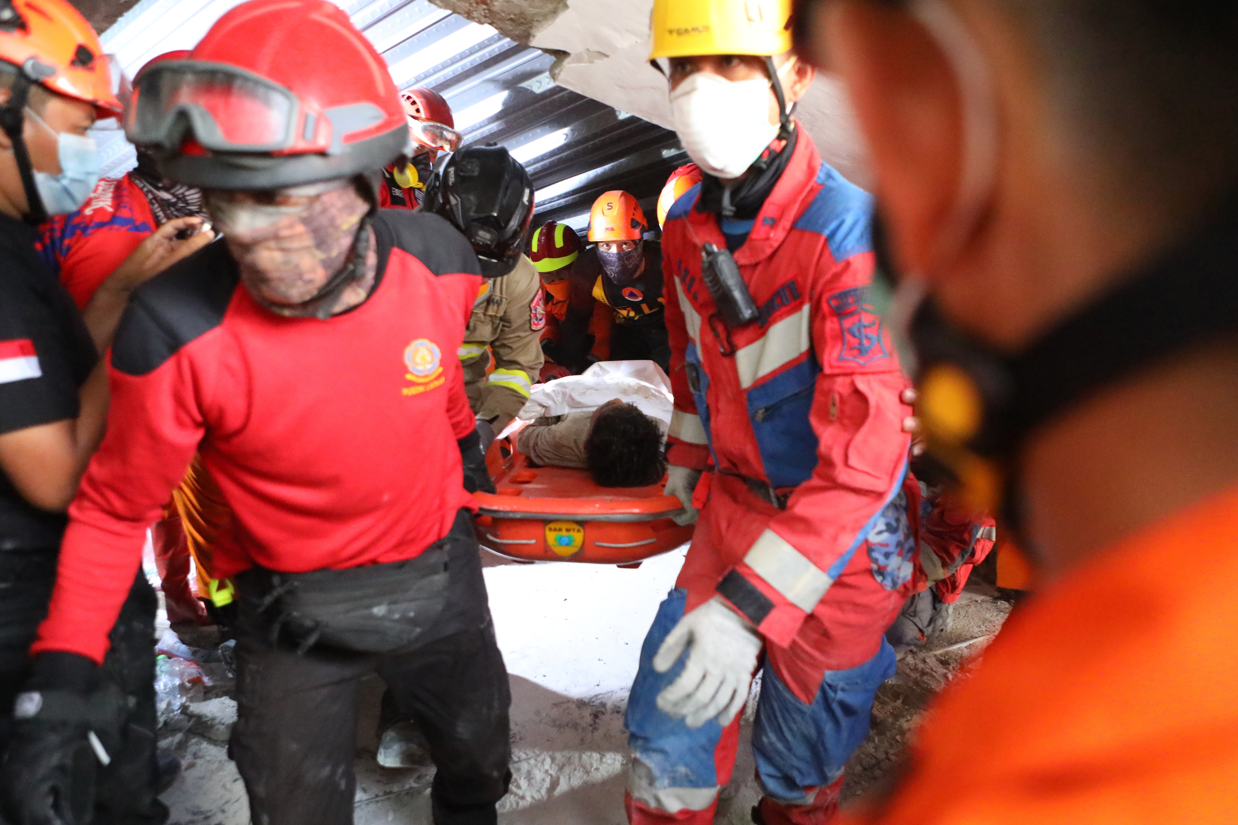 Children found alive beneath rubble of collapsed Indonesian school