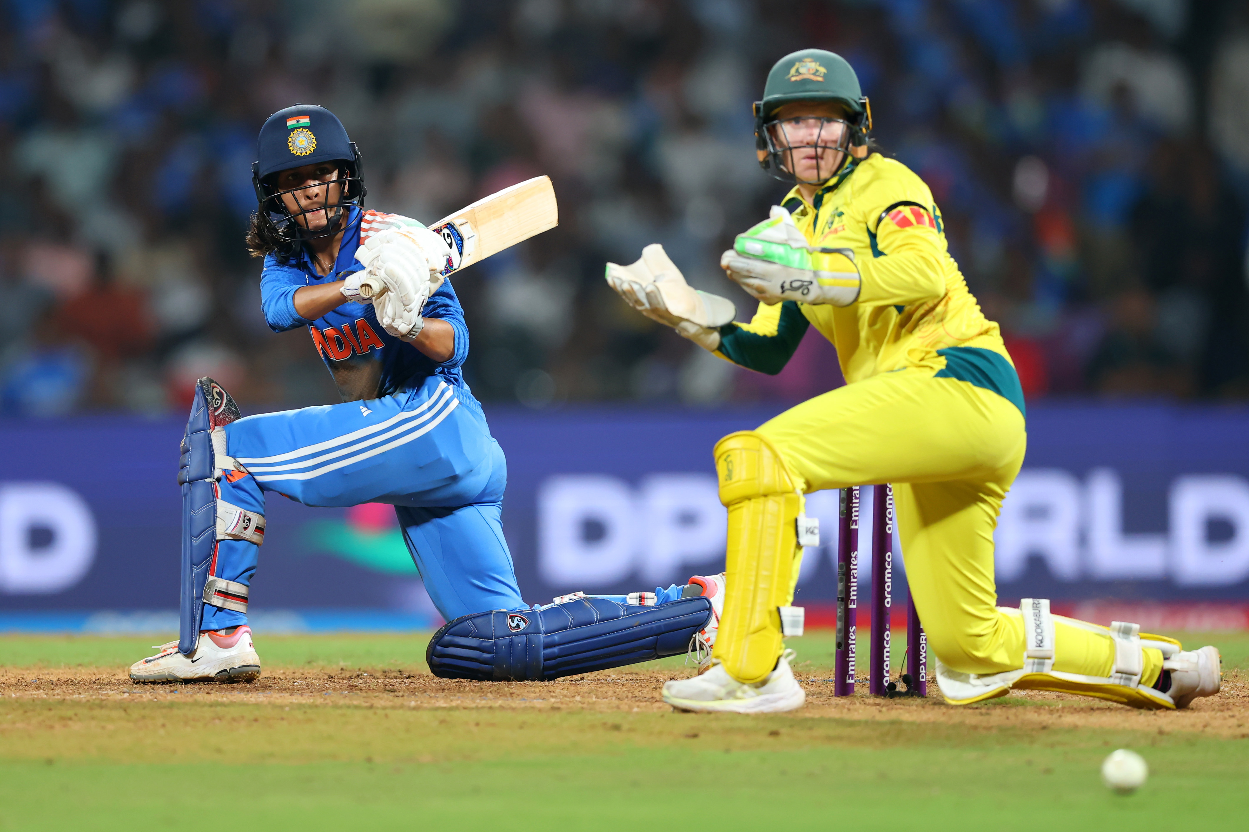 India's Jemimah Rodrigues bats while Australia's wicketkeeper Alyssa Healy looks on during their ICC Women's Cricket World Cup India 2025 semi final.