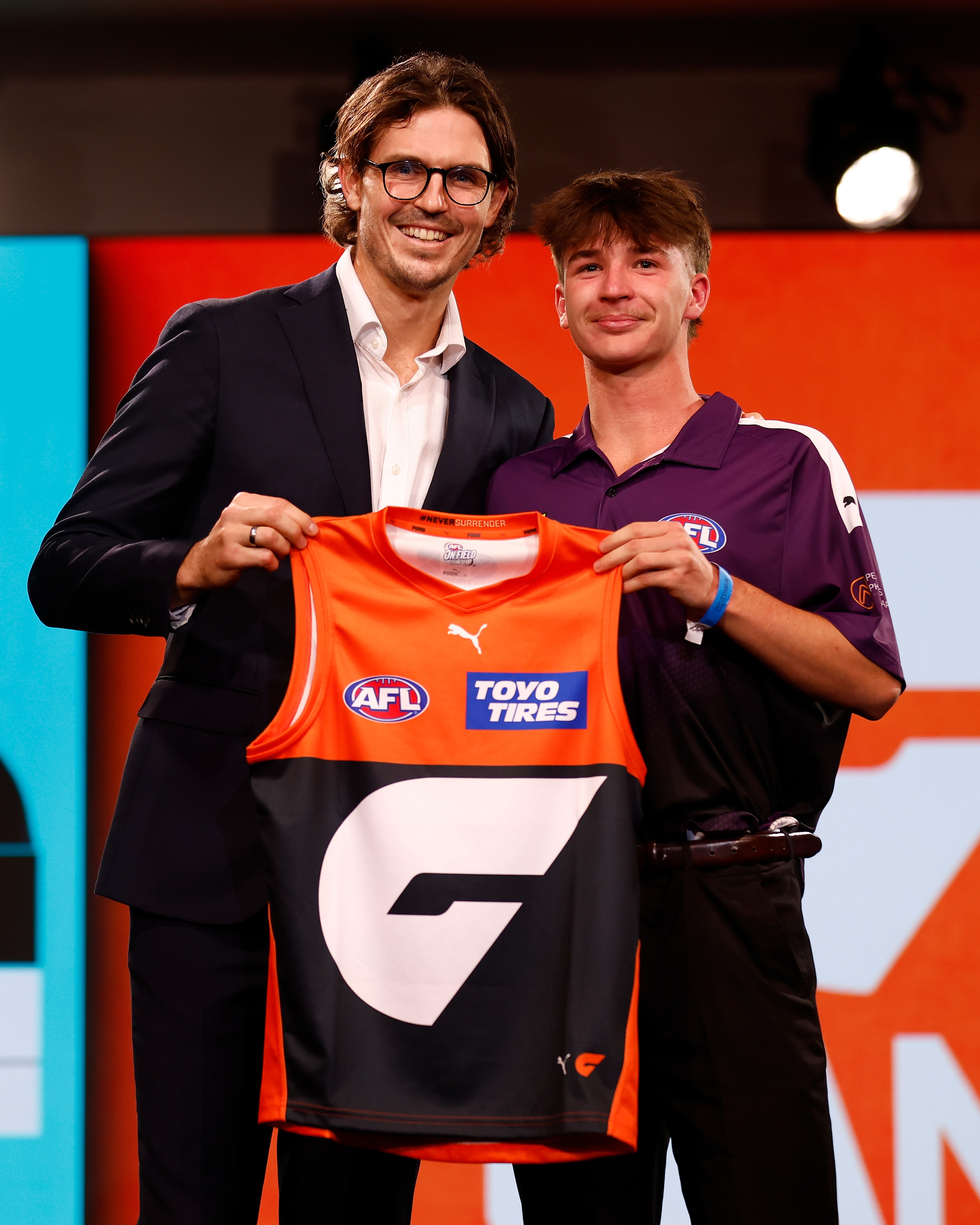 An emotional Phoenix Gothard is presented his GWS jumper by Phil Davis.