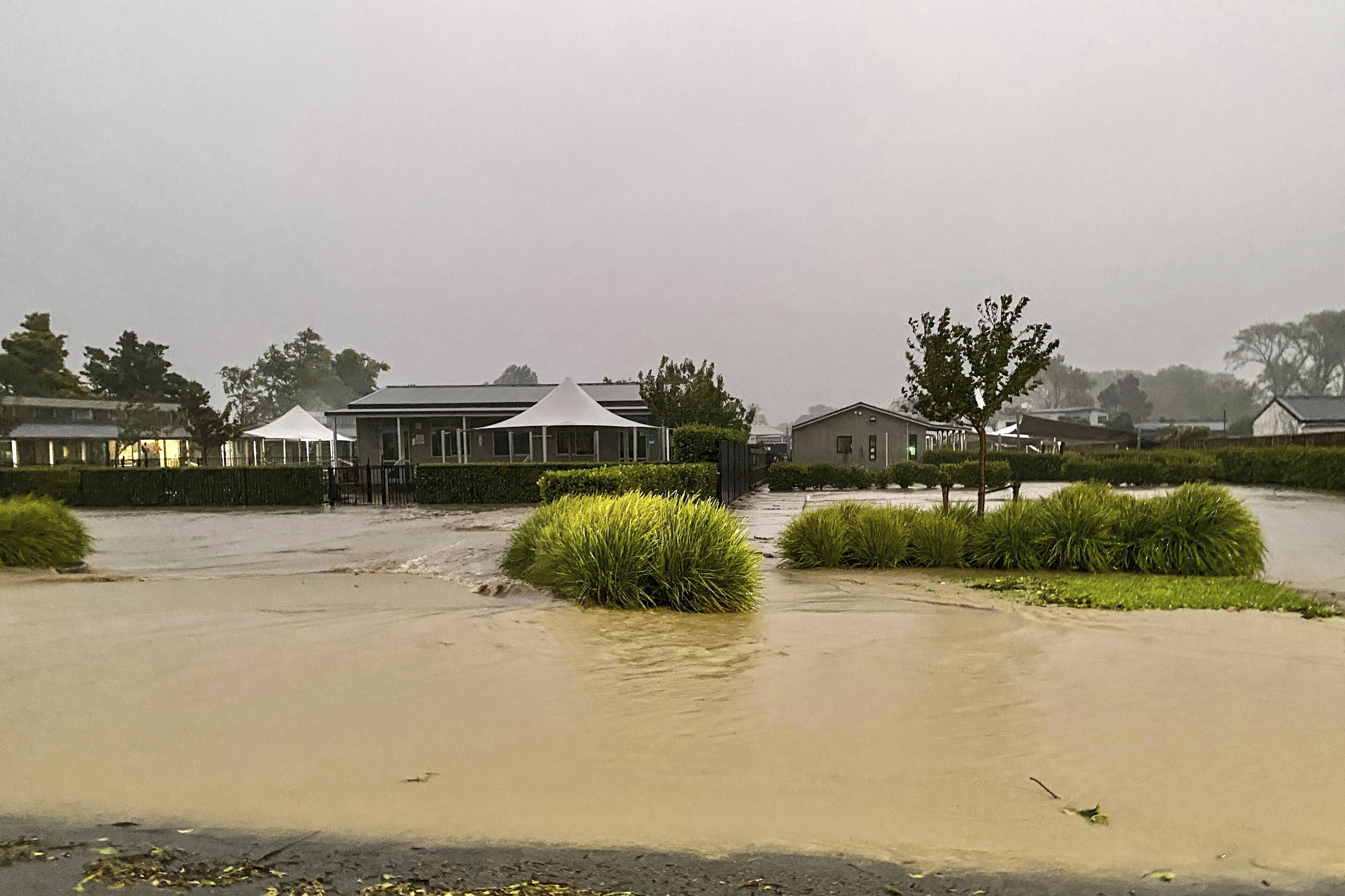 Water floods a street in Havelock North, southeast of Auckland, New Zealand, Tuesday, Feb. 14, 2023. 