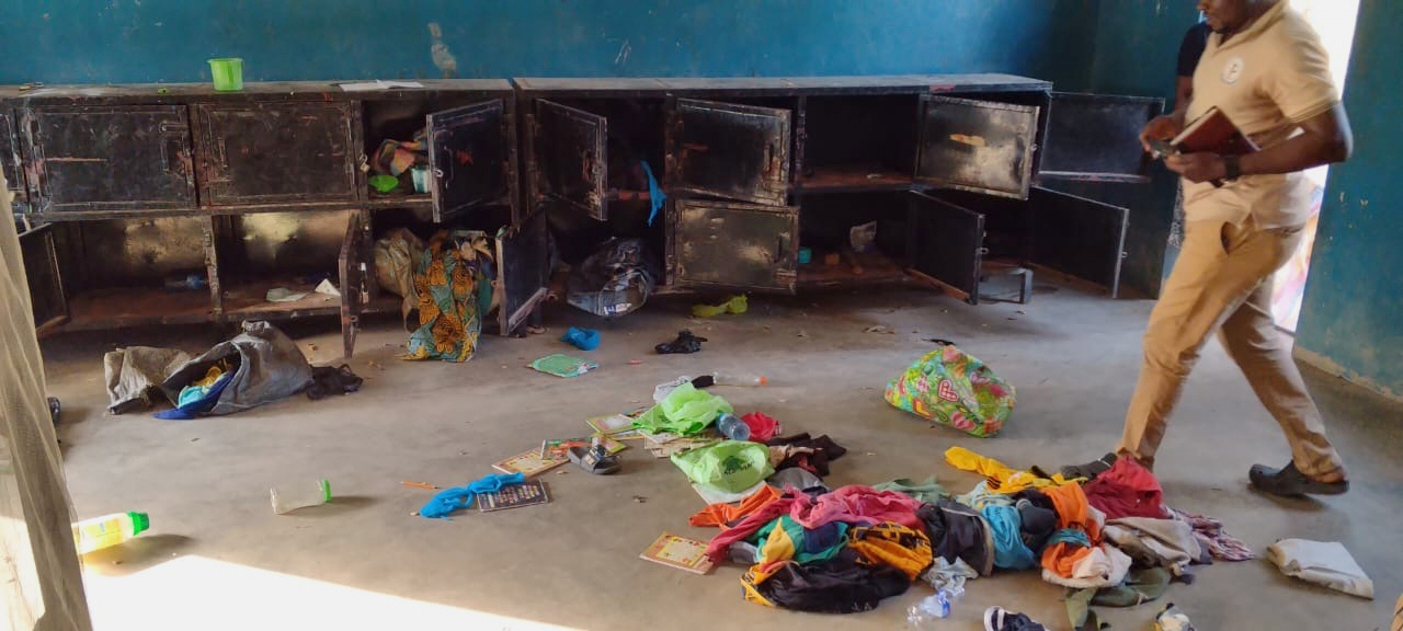 A man walk past belongings at the St. Mary's Catholic Primary and Secondary School after gunmen abducted children and staff in Papiri community, Nigeria, Friday, Nov. 21, 2025. (Christian Association of Nigeria via AP)