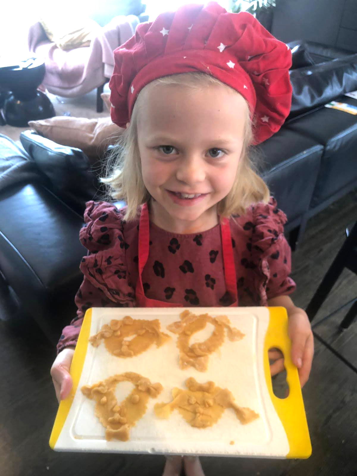 Sienna Guise, now 8, holds a tray of pasta she made during the first lockdown in New Zealand.