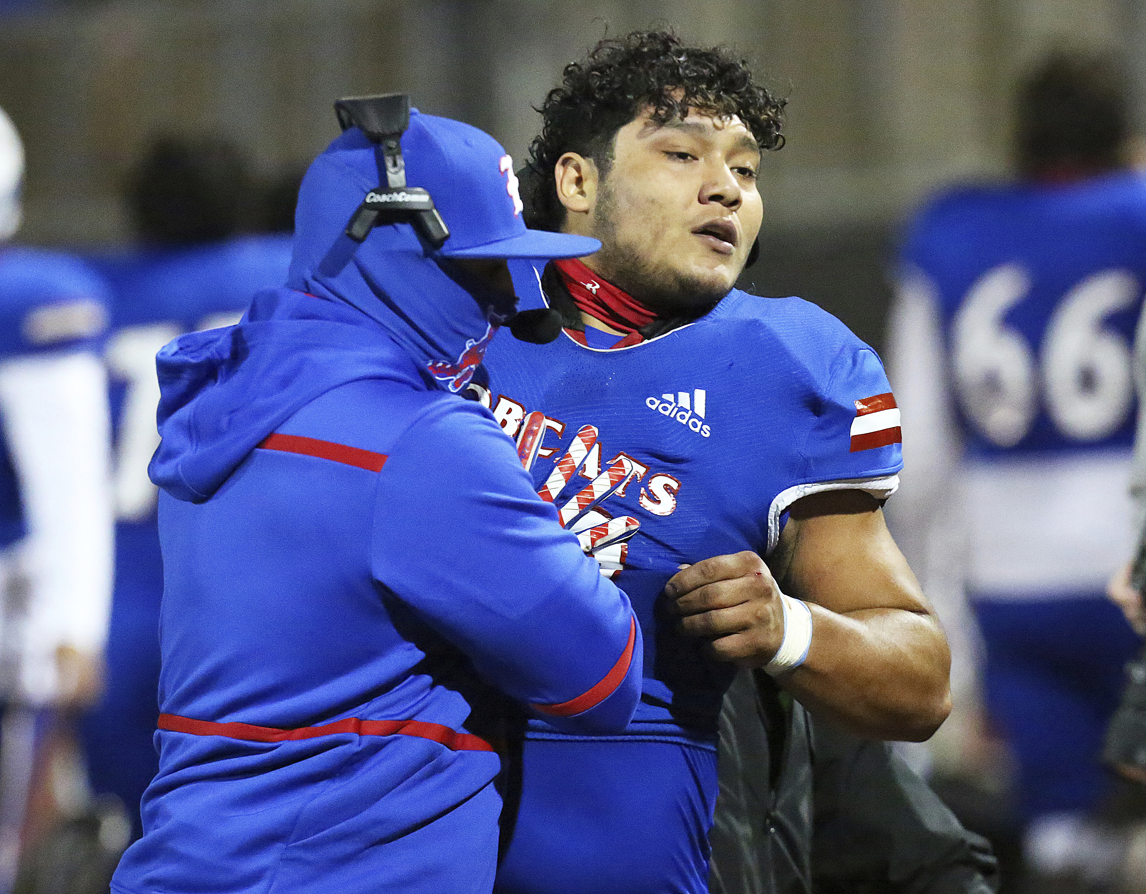 Edinburg High's Emmanuel Duron is pulled from the field by coaching staff after charging a referee.