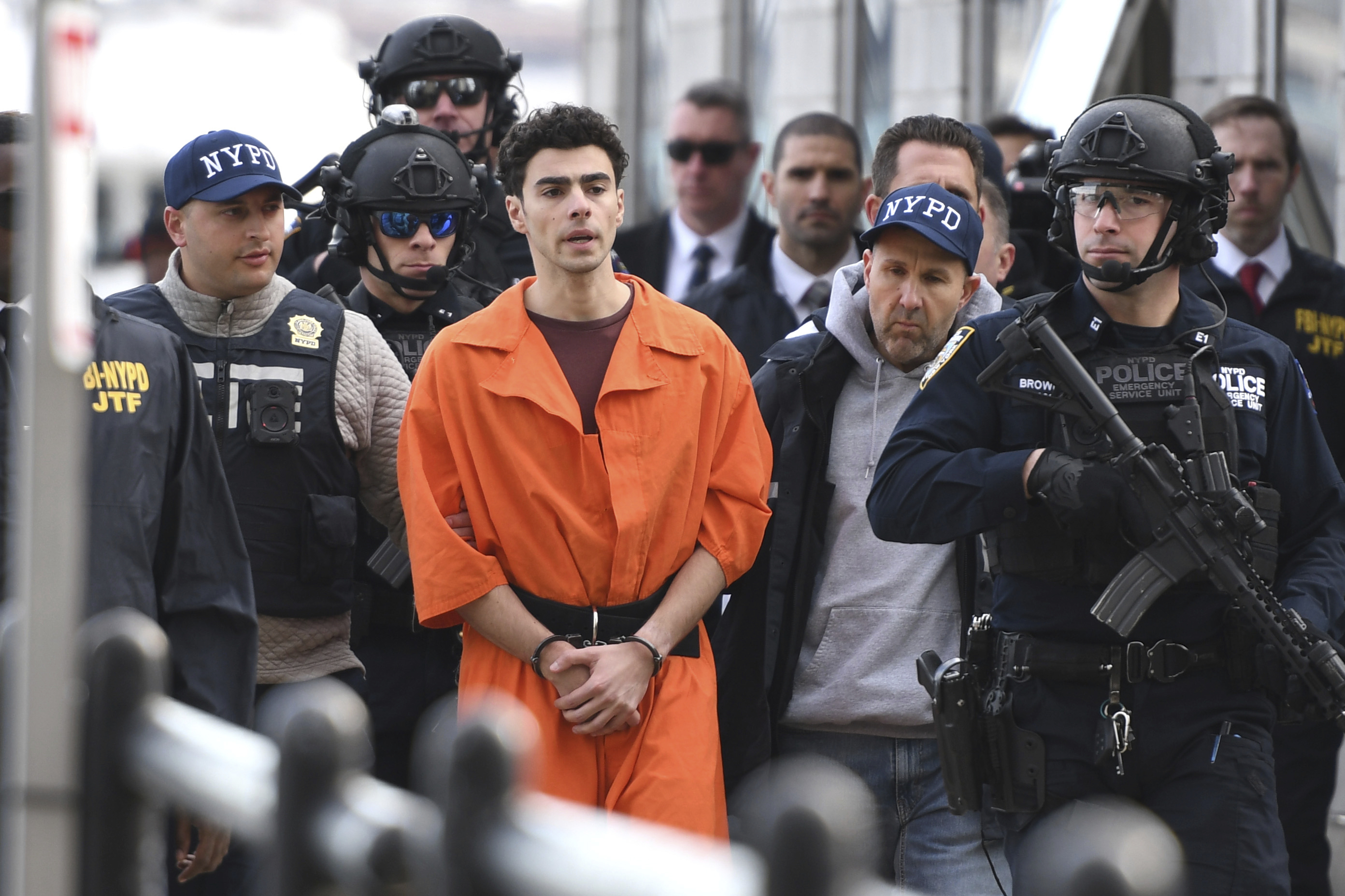 Luigi Mangione, a suspect in the fatal shooting of UnitedHealthcare CEO Brian Thompson, is escorted by police, Thursday, Dec. 19, 2024, in New York. (AP Photo/Pamela Smith)