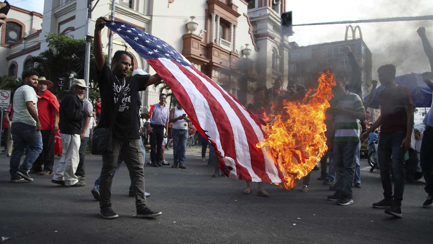 An American flag is burned during a protest in San Pedro Sula, Honduras.