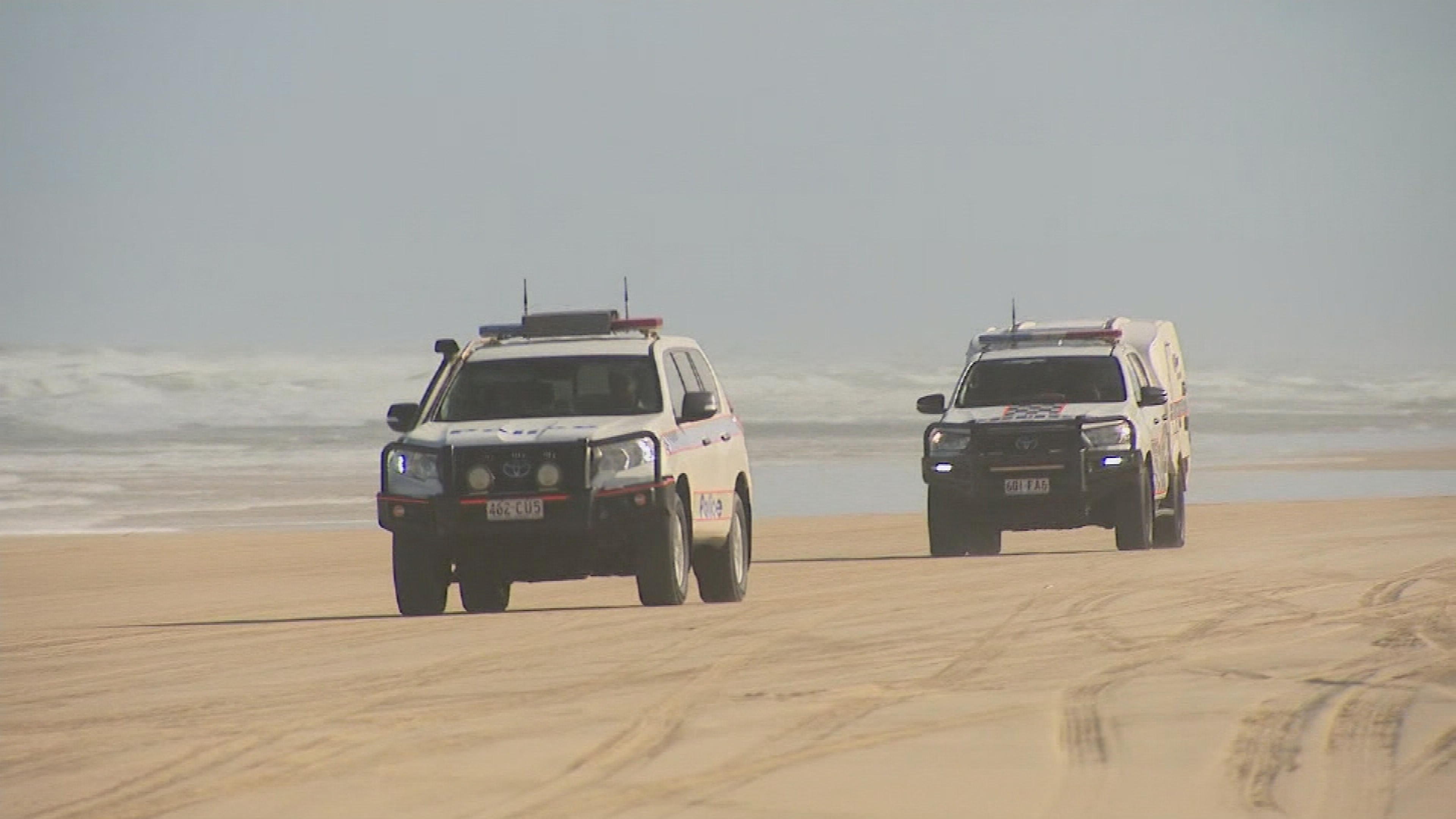 Police have been left "traumatised" after a 19-year-old Canadian woman was found dead and surrounded by 10 dingoes on the Queensland island of K'gari this morning.
