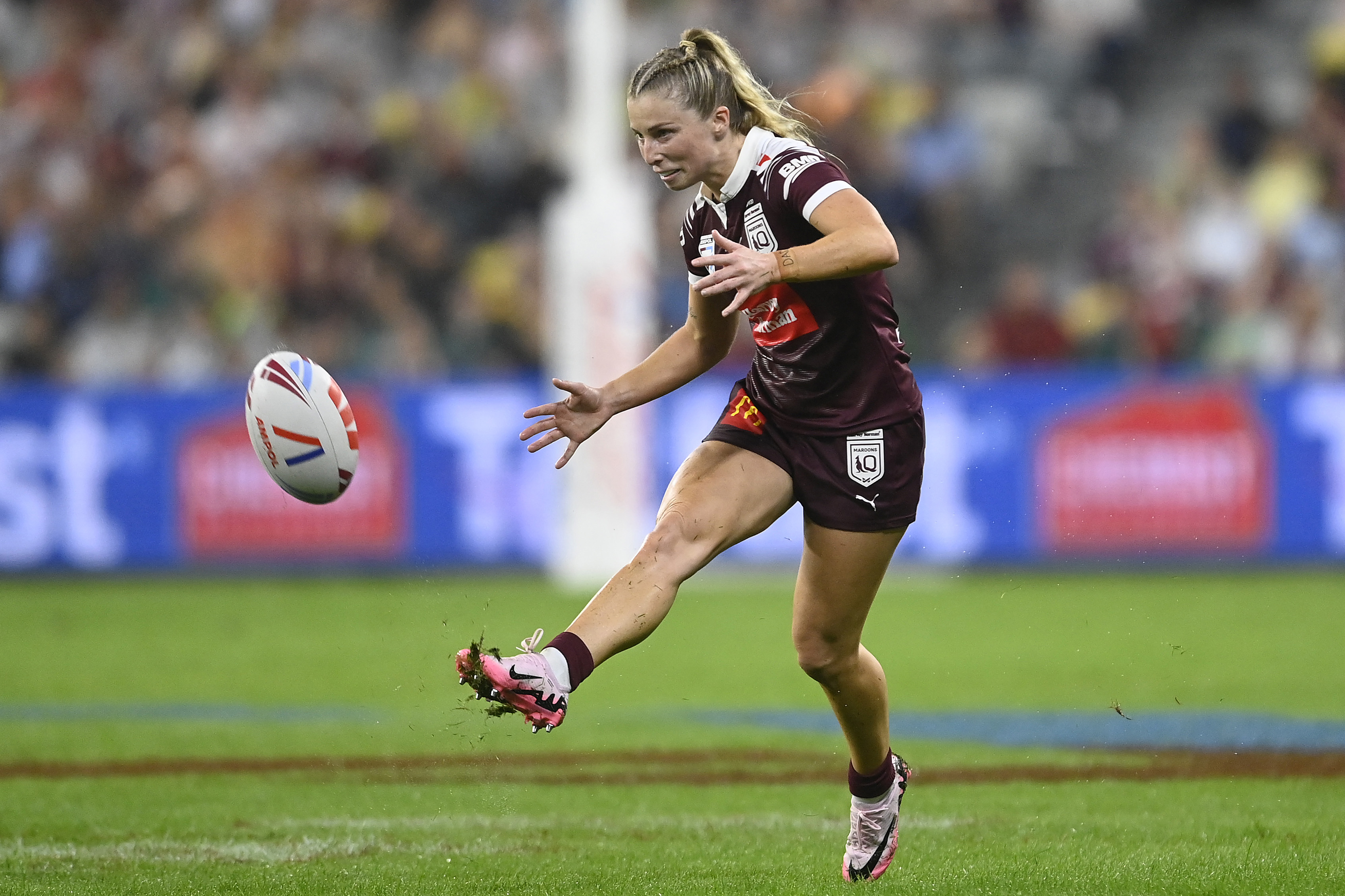 Tarryn Aiken of the Maroons kicks the ball.