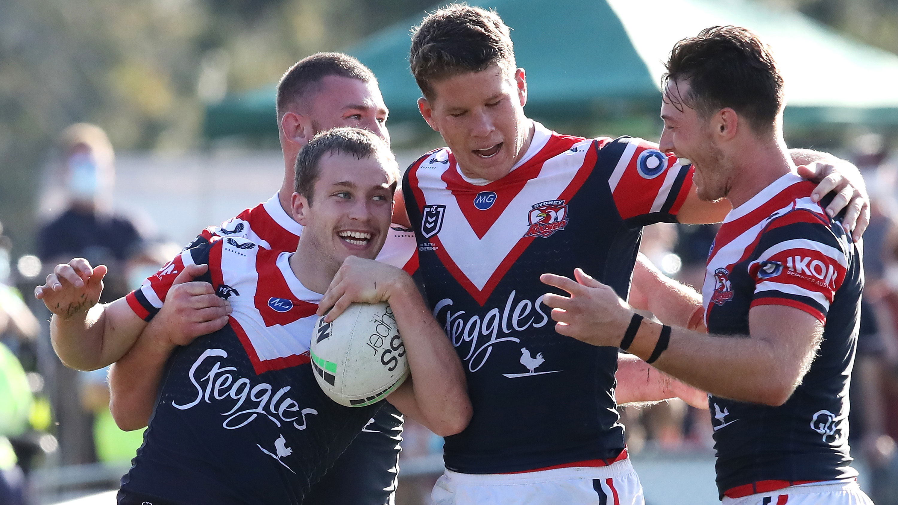 Sam Walker of the Roosters celebrates with his team mates Fletcher Baker, Egan Butcher and Sam Verrills. 